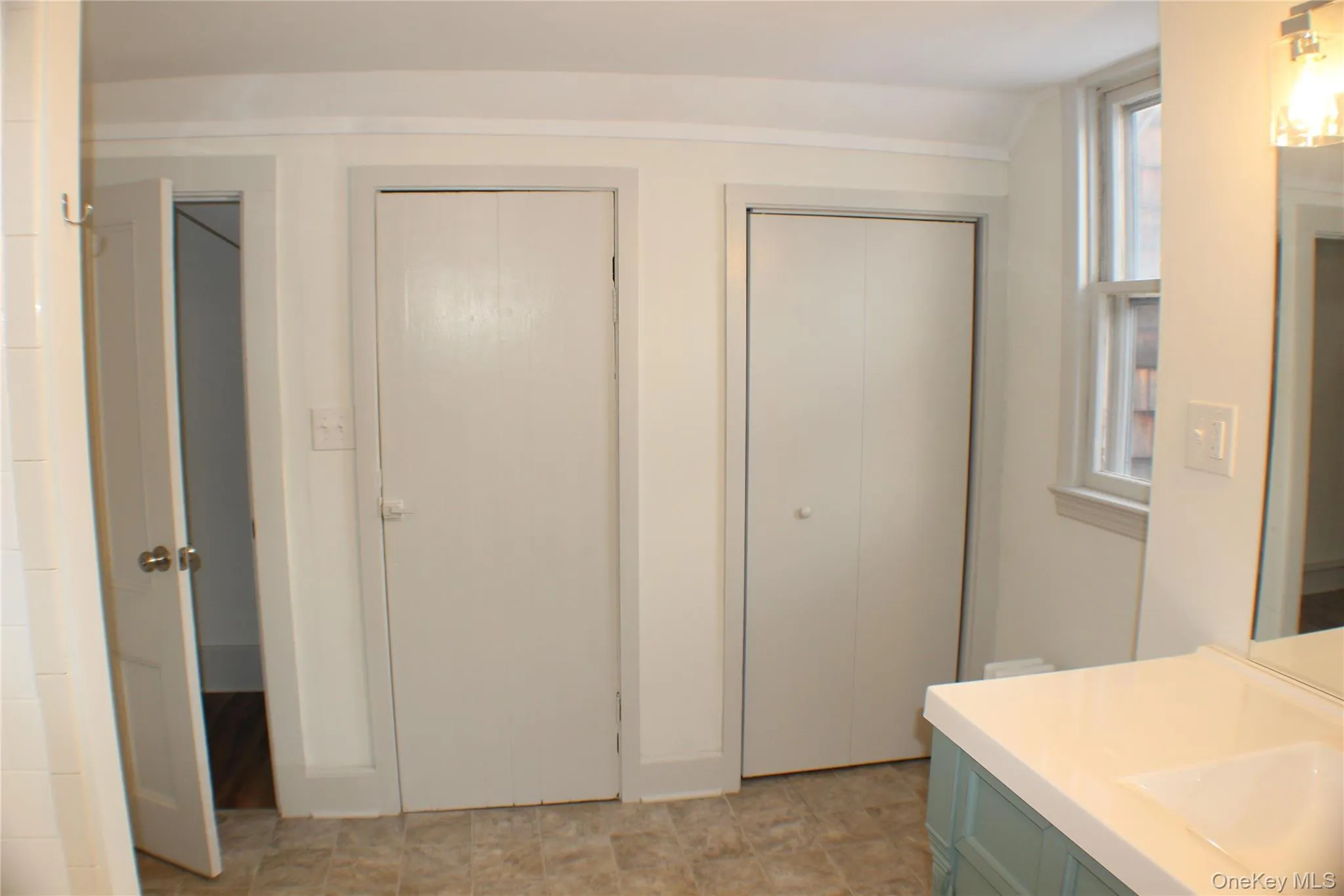 Bathroom featuring vanity, a closet, and a shower Bathroom featuring vanity, a closet, and a shower