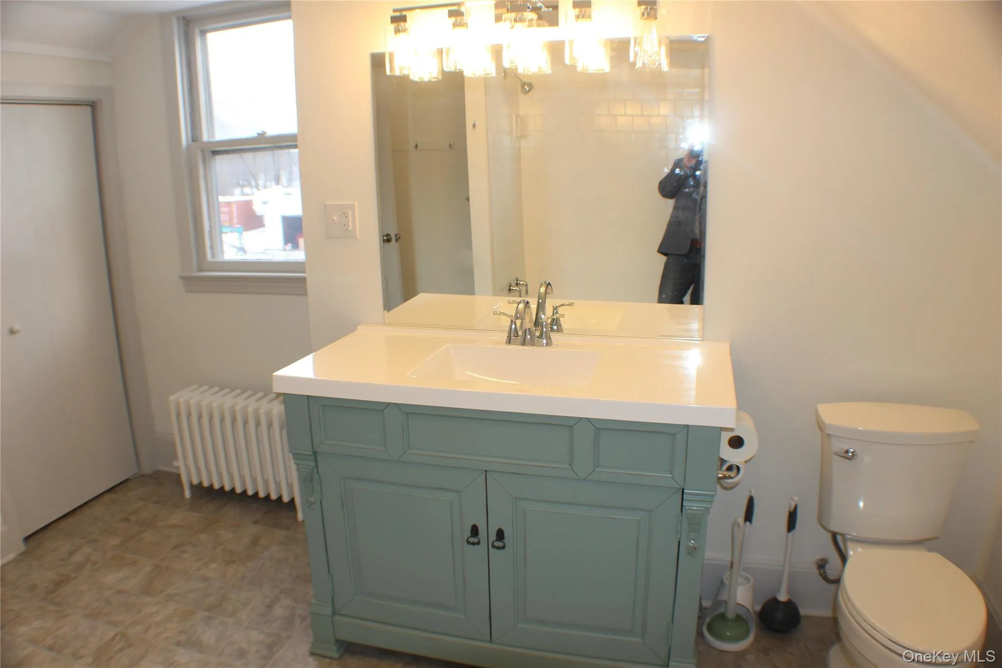 Bathroom with radiator heating unit and vanity Bathroom with radiator heating unit and vanity