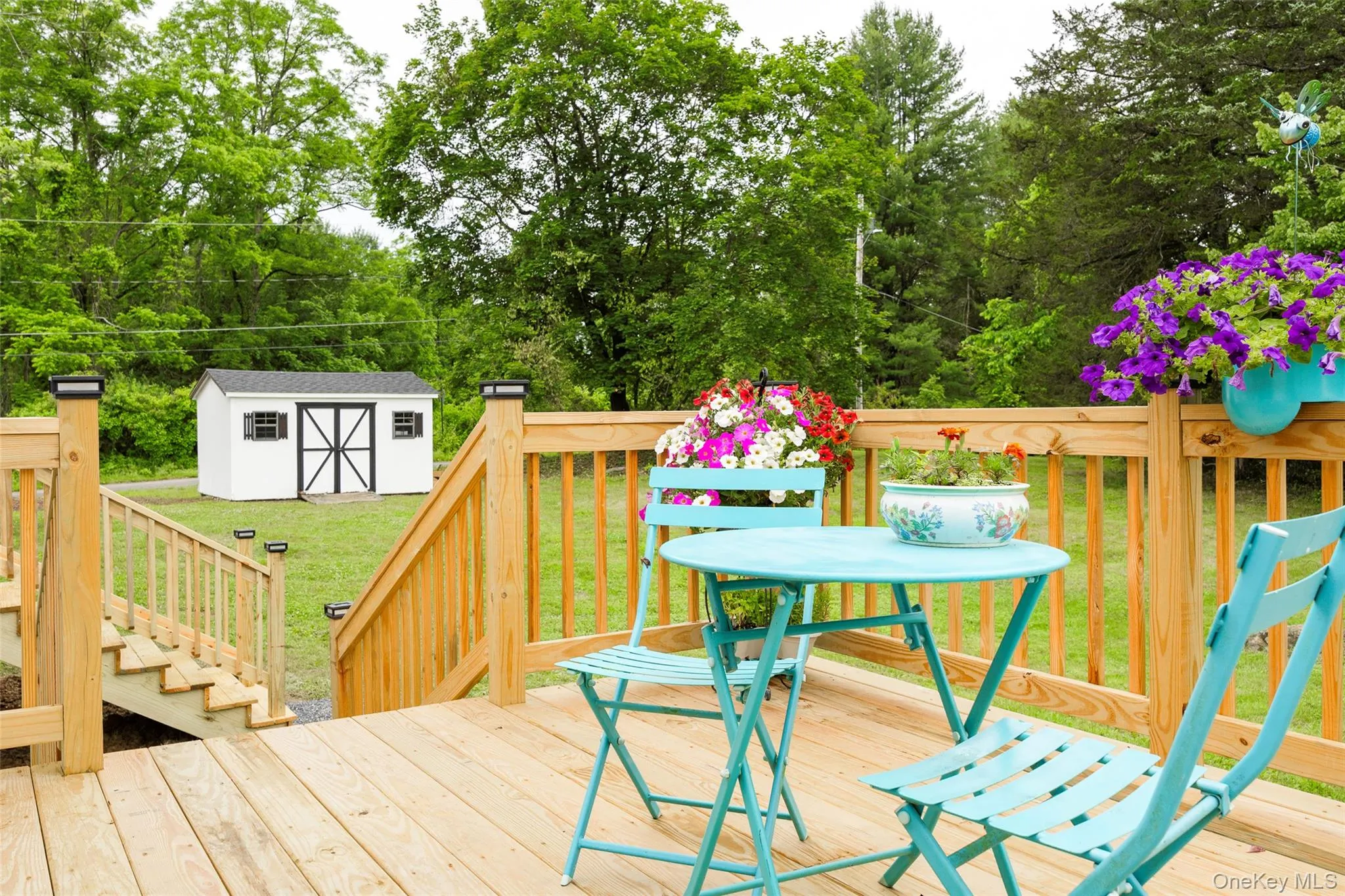 Wooden deck with a yard and a storage unit Wooden deck with a yard and a storage unit