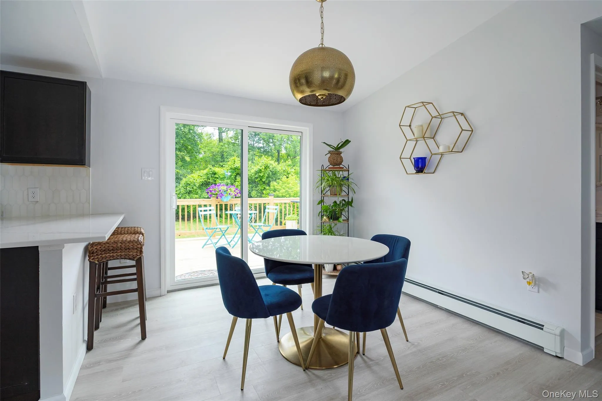 Dining room with a baseboard radiator and light wood-style floors Dining room with a baseboard radiator and light wood-style floors