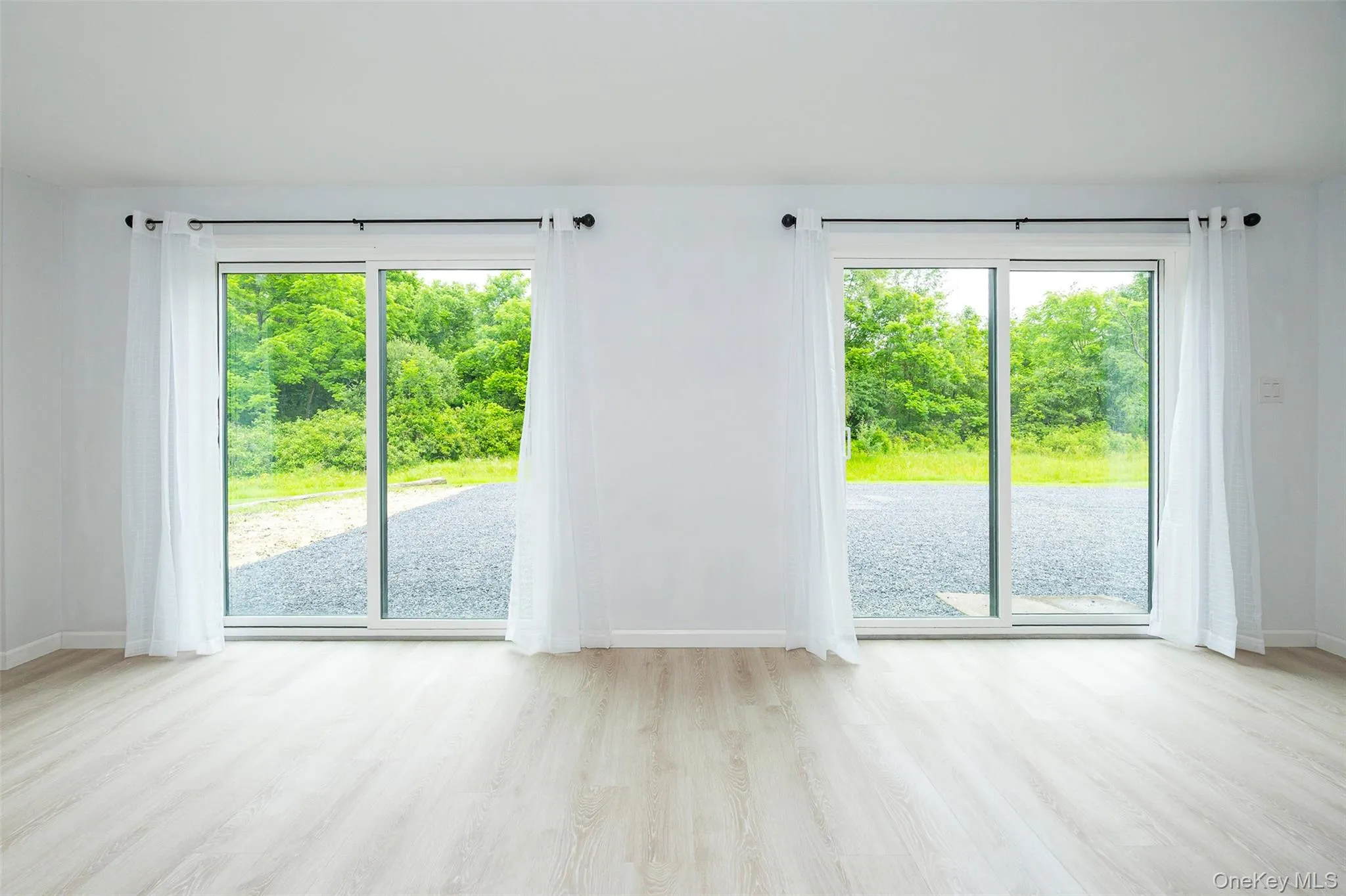 Unfurnished room with wood finished floors and healthy amount of natural light Unfurnished room with wood finished floors and healthy amount of natural light
