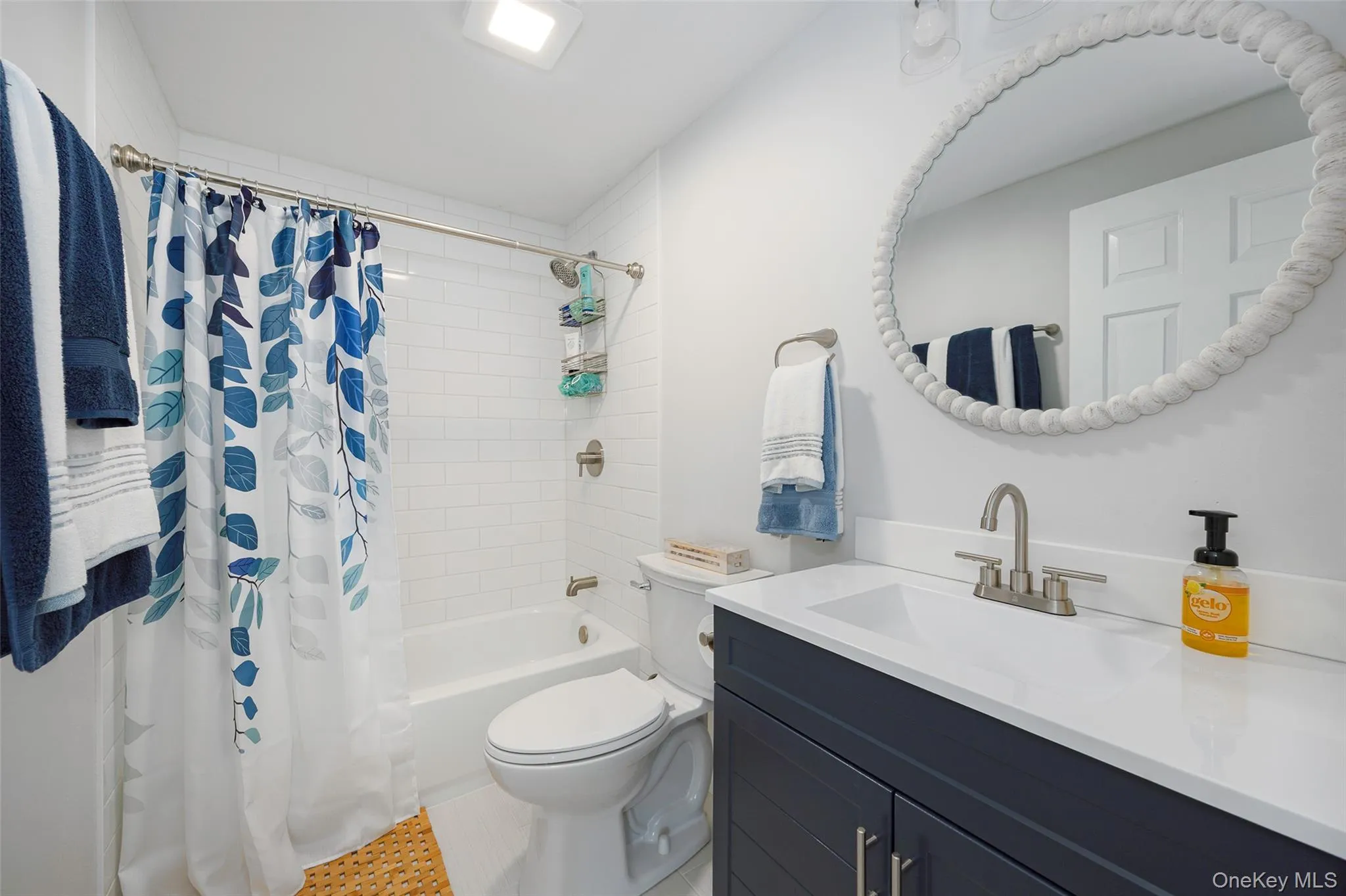 Full bathroom featuring vanity, shower / bath combo, and tile patterned flooring Full bathroom featuring vanity, shower / bath combo, and tile patterned flooring