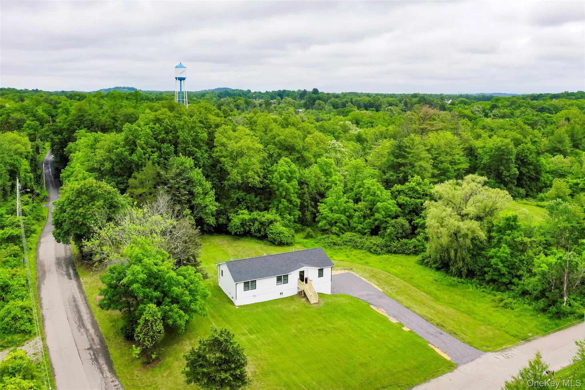 View from above of property with a heavily wooded area View from above of property with a heavily wooded area