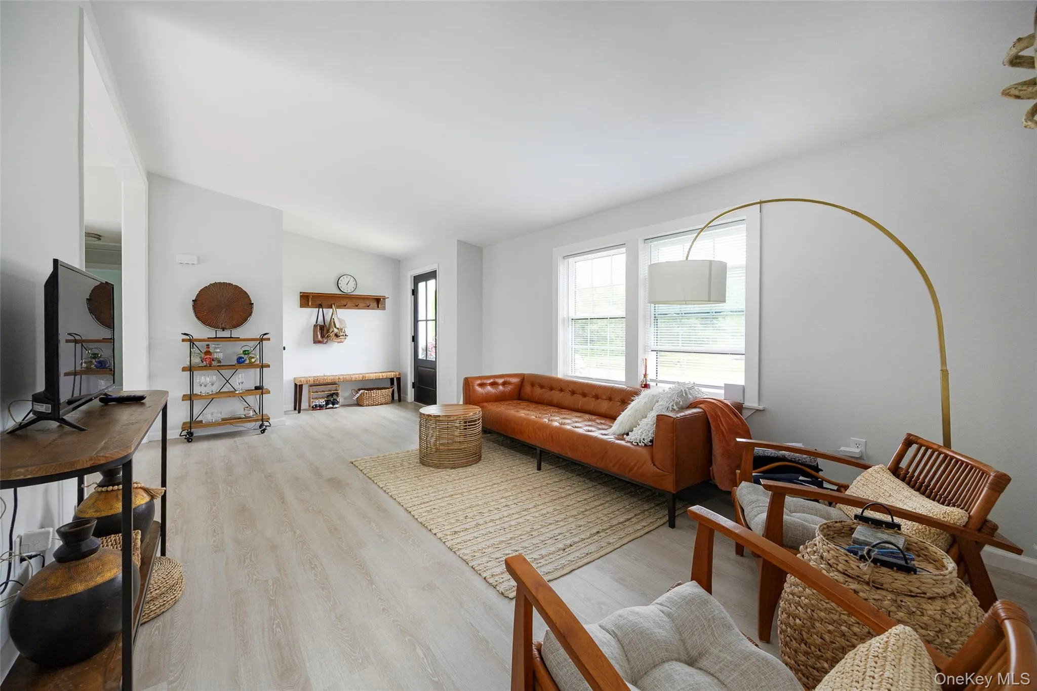 Living room with vaulted ceiling and light wood-style floors Living room with vaulted ceiling and light wood-style floors