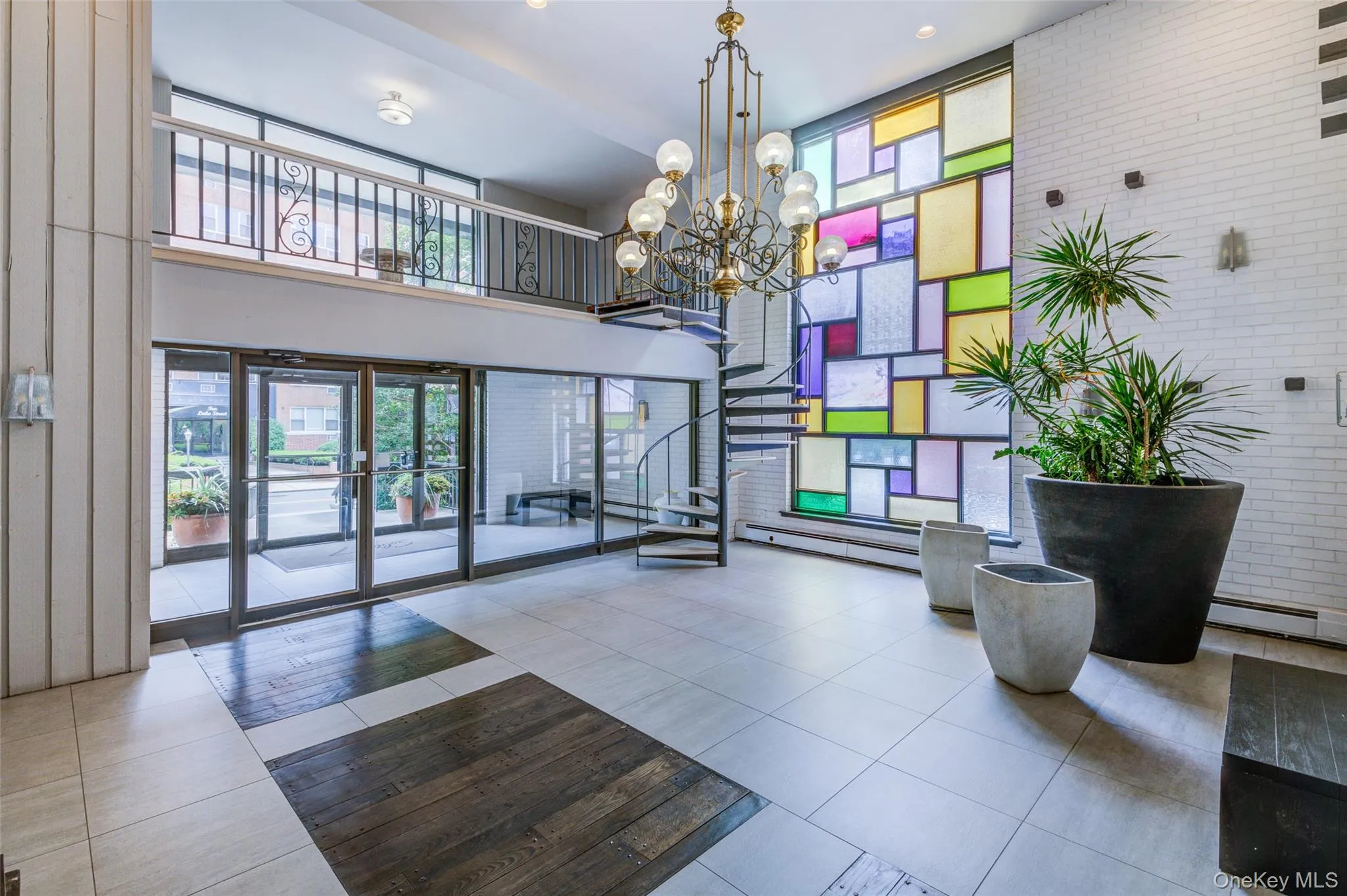 Building lobby with a high ceiling, stairs, and brick wall Building lobby with a high ceiling, stairs, and brick wall