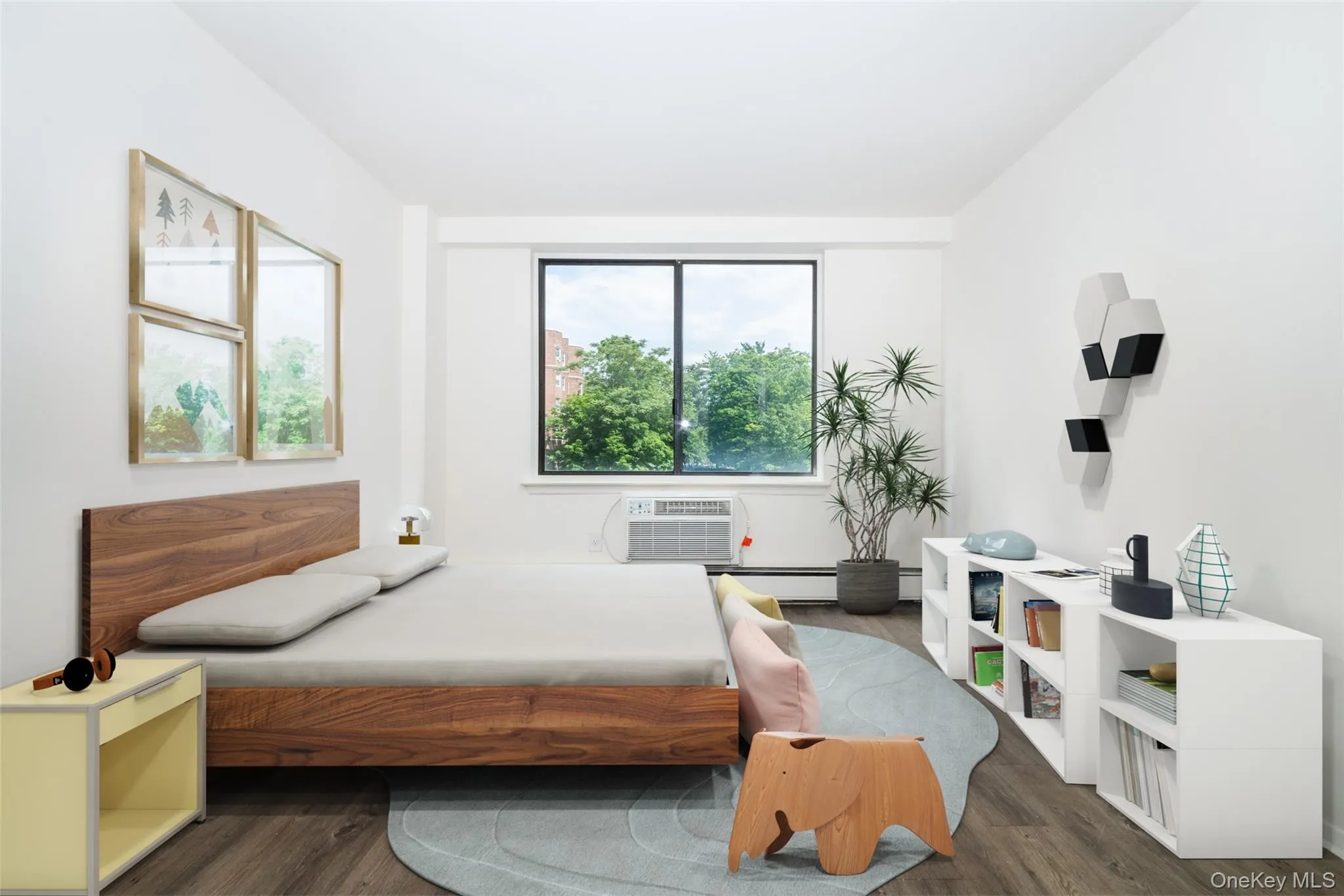 Bedroom with dark wood finished floors and a baseboard heating unit Bedroom with dark wood finished floors and a baseboard heating unit
