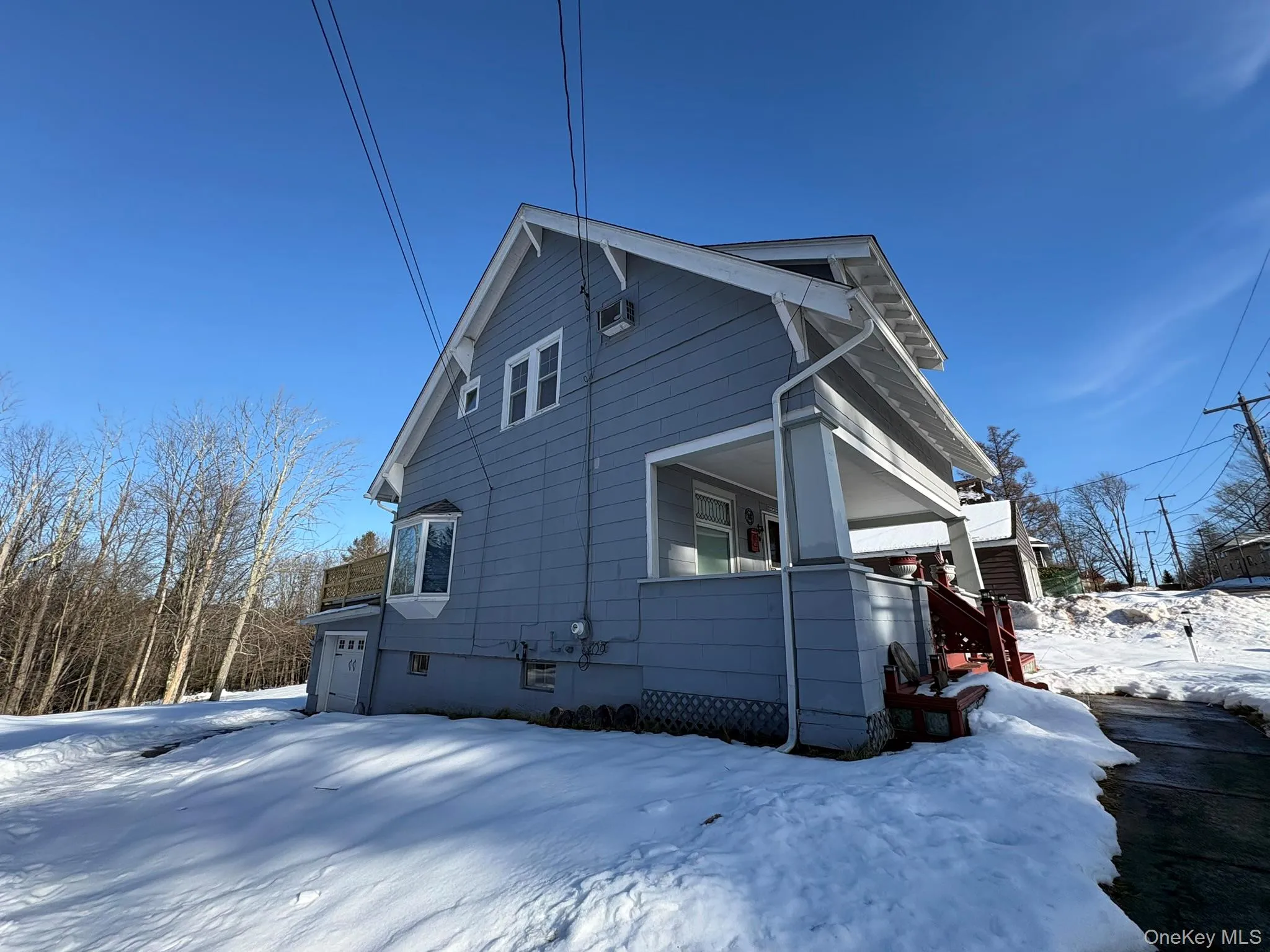 View of snow covered exterior featuring stairway View of snow covered exterior featuring stairway
