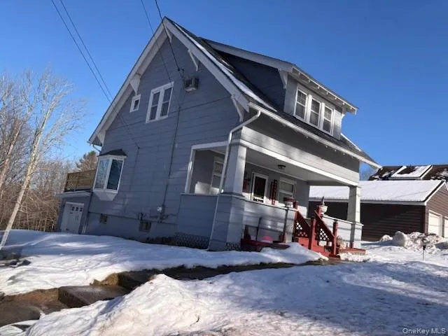 View of front of property with covered porch and a garage View of front of property with covered porch and a garage