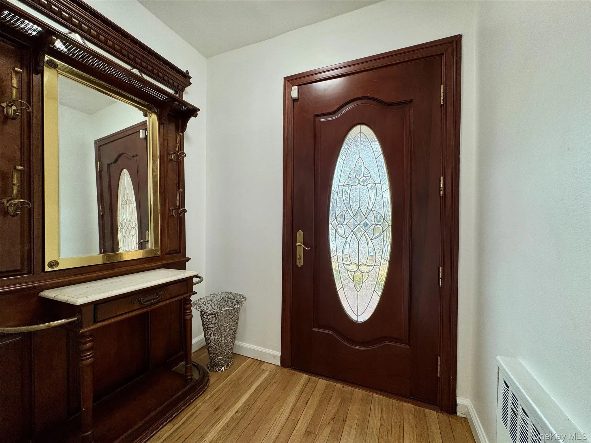Entryway featuring light wood-style flooring and baseboards Entryway featuring light wood-style flooring and baseboards