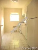 Kitchen featuring white appliances and white cabinets Kitchen featuring white appliances and white cabinets