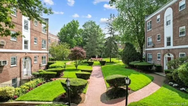 View of property's community with a yard View of property's community with a yard