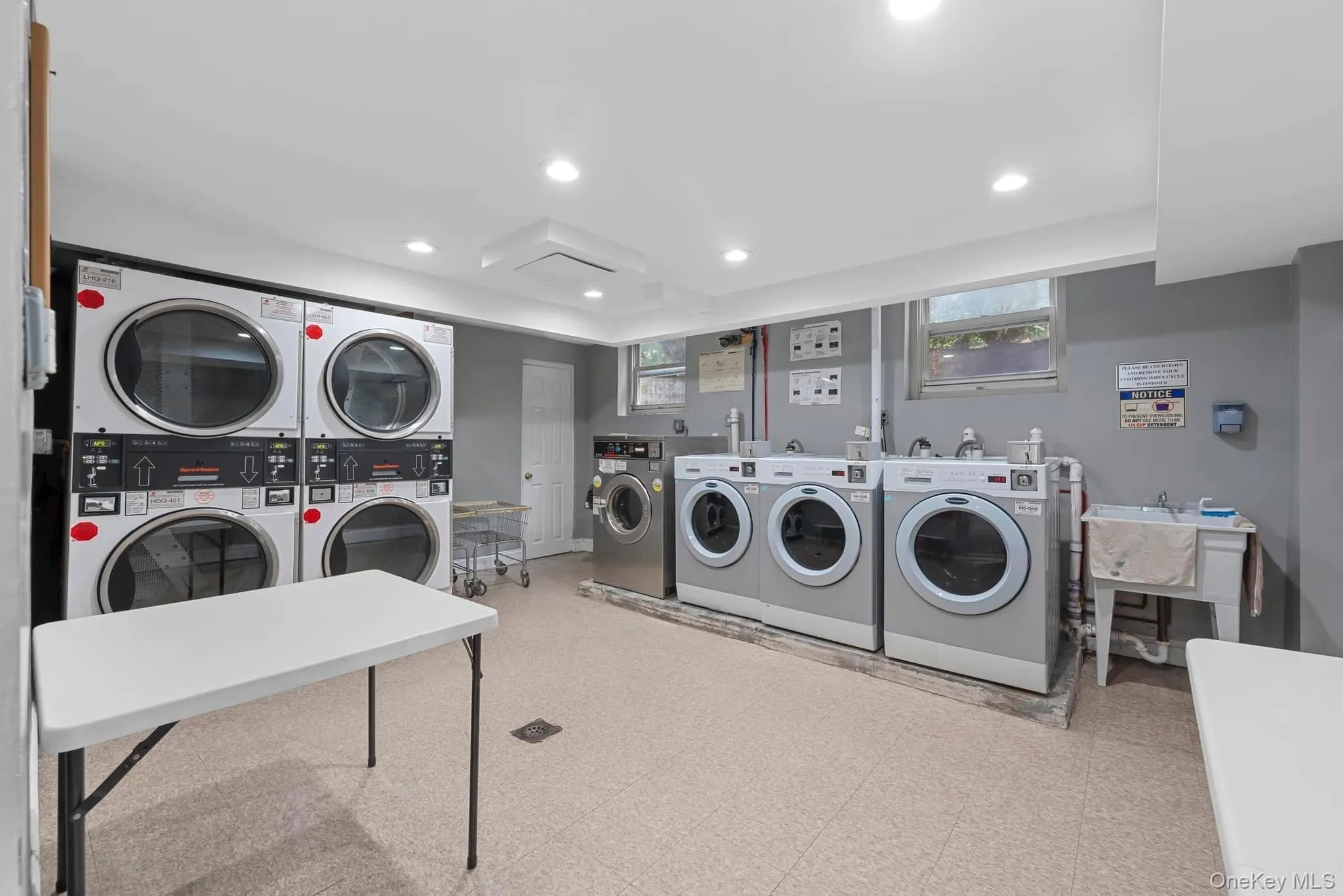 Community laundry with recessed lighting and washing machine and clothes dryer Community laundry with recessed lighting and washing machine and clothes dryer