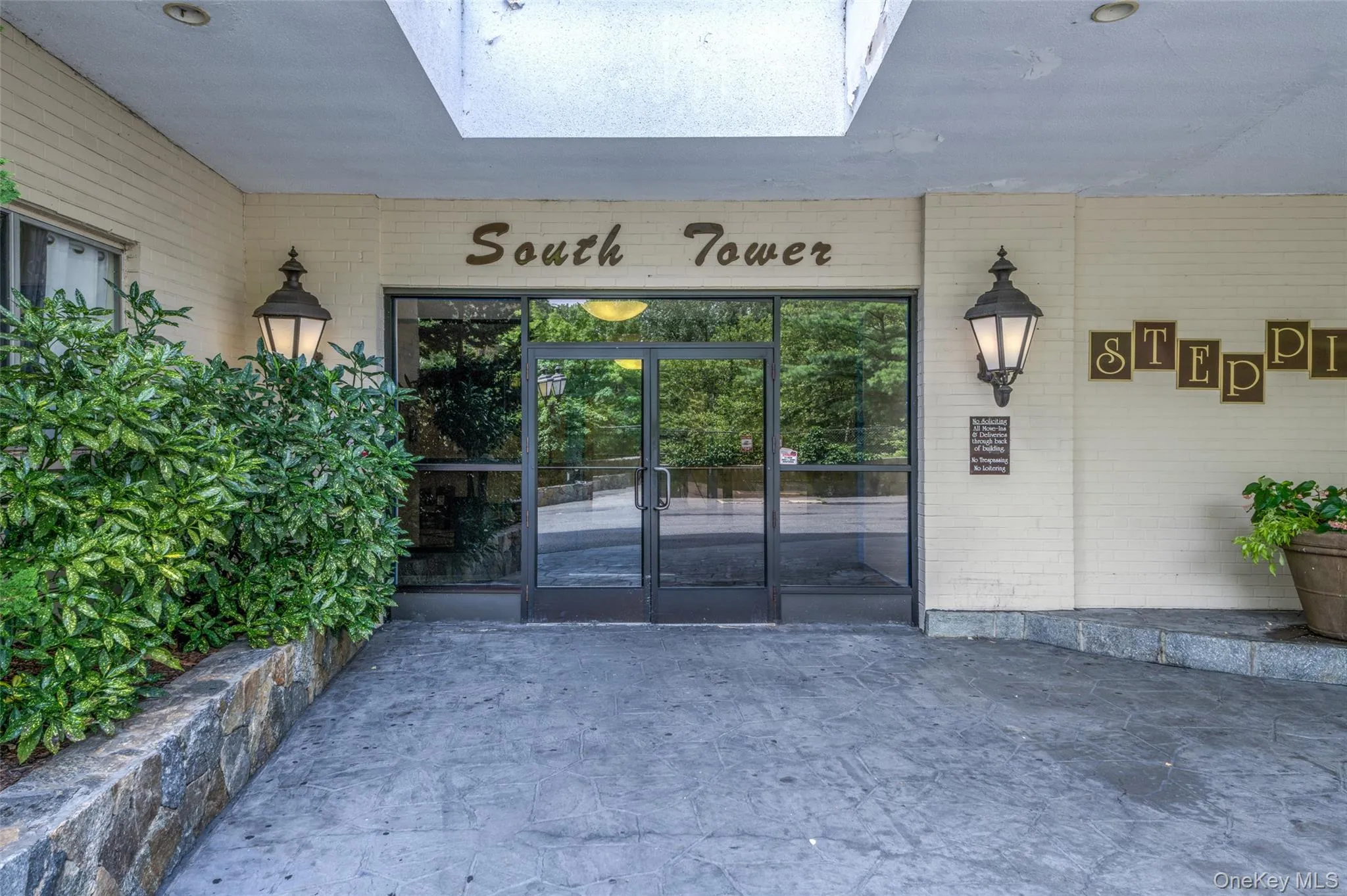 Doorway to property featuring brick siding and french doors Doorway to property featuring brick siding and french doors