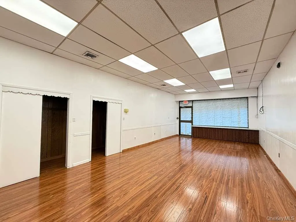 Spare room featuring hardwood / wood-style flooring and a paneled ceiling Spare room featuring hardwood / wood-style flooring and a paneled ceiling