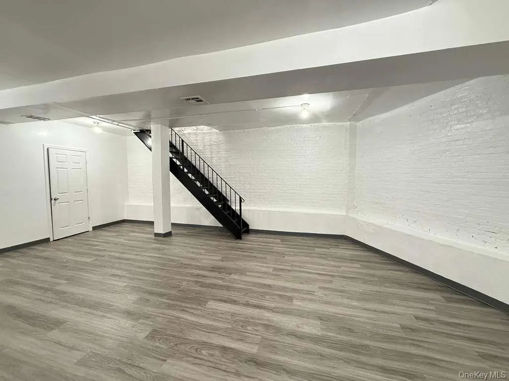 Finished below grade area with stairway and wood finished floors Finished below grade area with stairway and wood finished floors