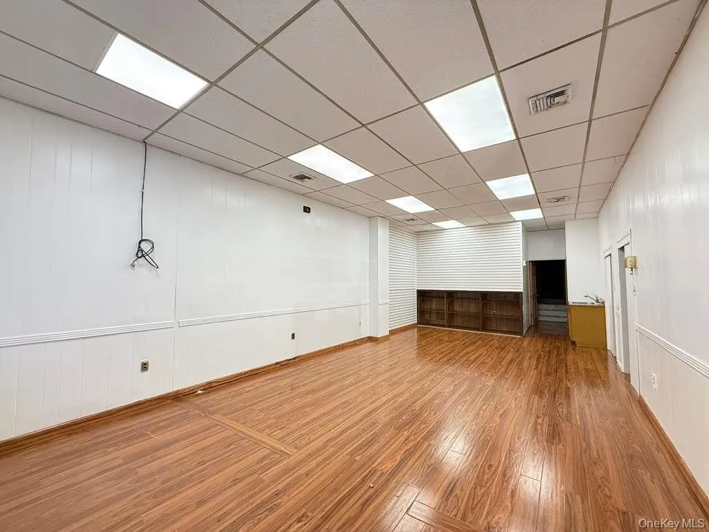 Empty room featuring hardwood / wood-style floors and a paneled ceiling Empty room featuring hardwood / wood-style floors and a paneled ceiling