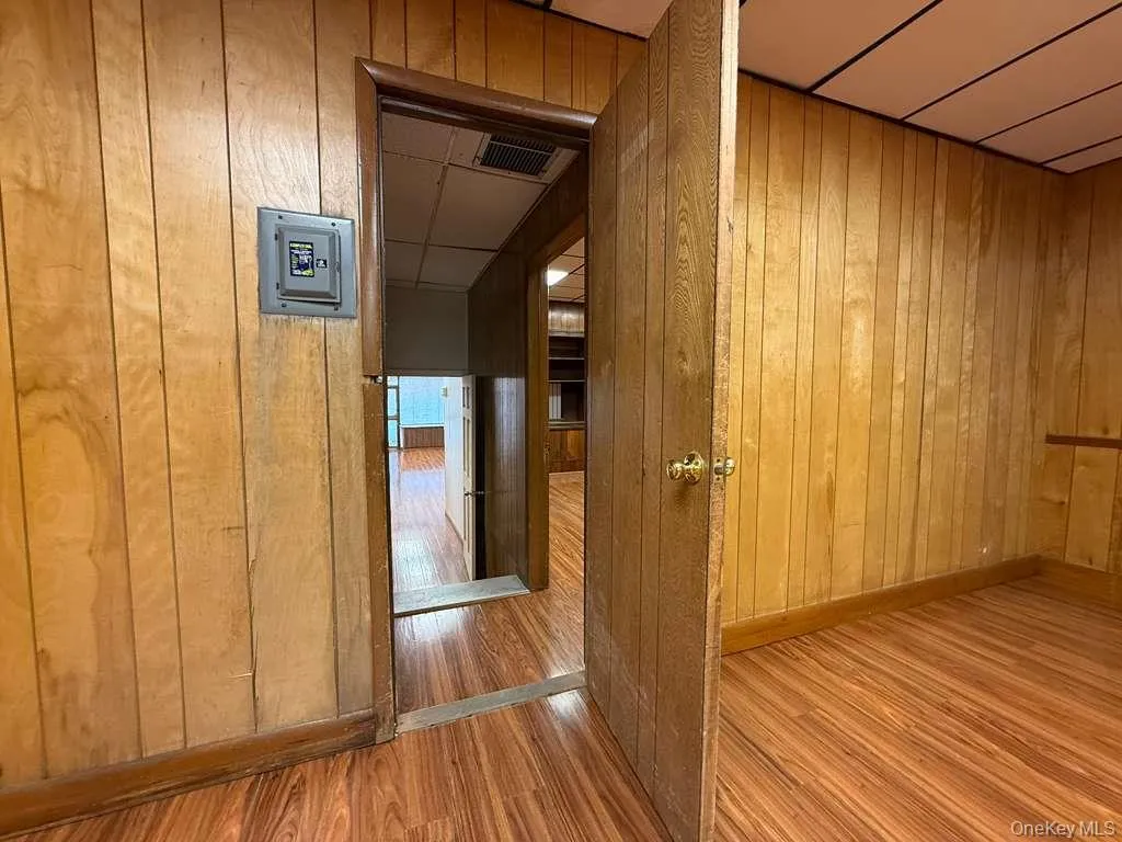 Hallway with wooden walls and wood finished floors Hallway with wooden walls and wood finished floors