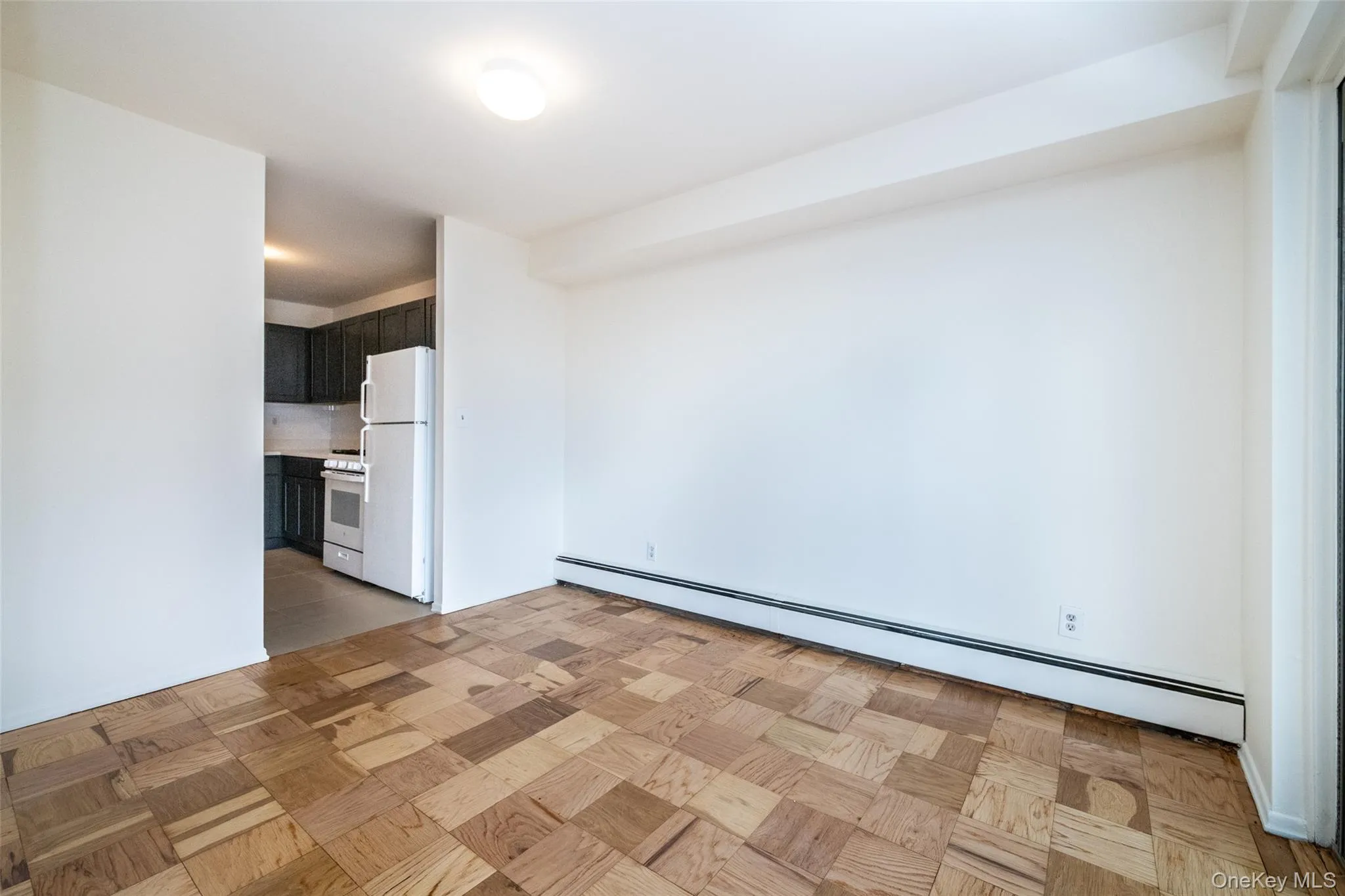 Unfurnished room with a baseboard radiator Unfurnished room with a baseboard radiator