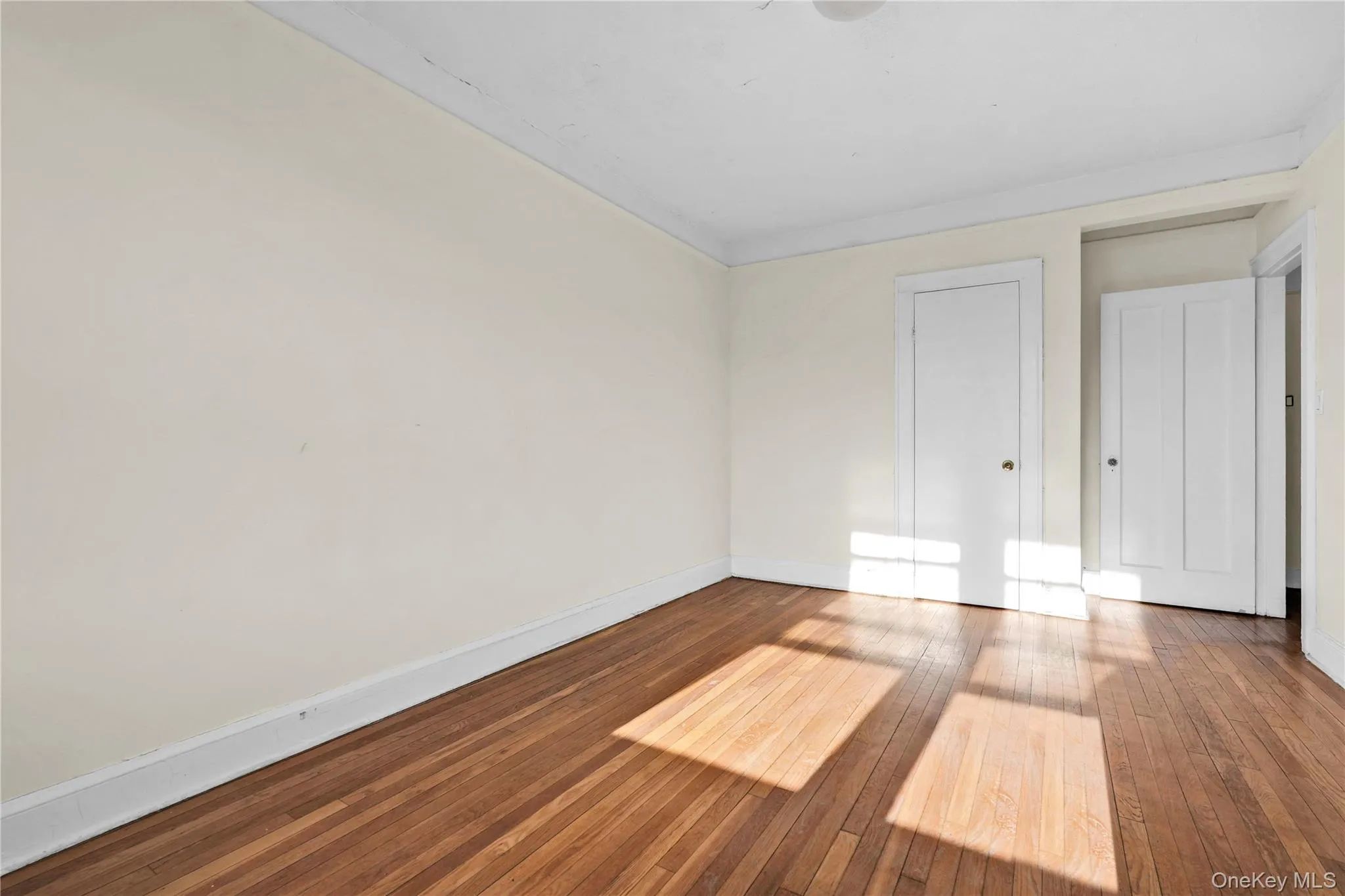 Unfurnished bedroom featuring hardwood / wood-style flooring and a closet Unfurnished bedroom featuring hardwood / wood-style flooring and a closet