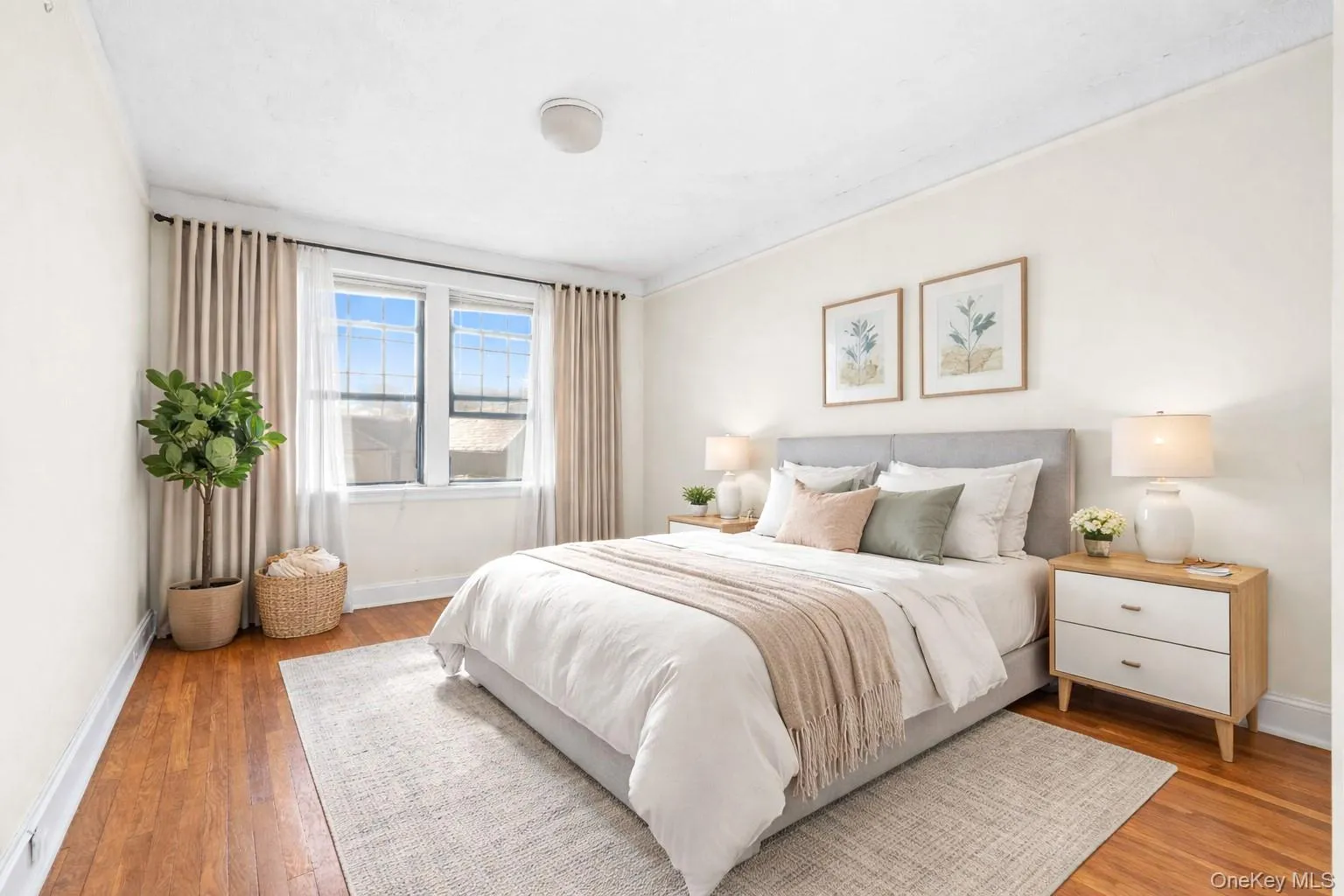 Bedroom featuring baseboards and wood-type flooring Bedroom featuring baseboards and wood-type flooring