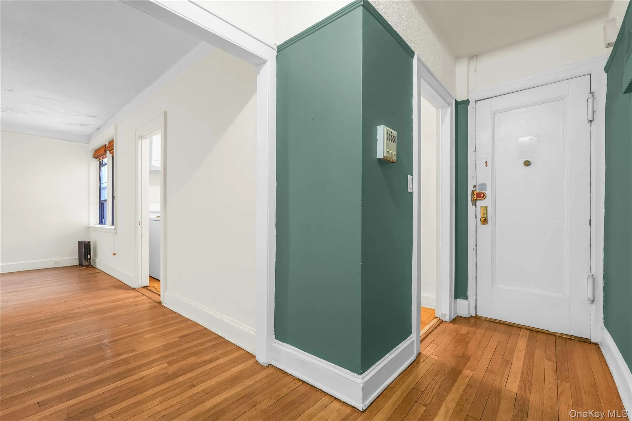 Hallway featuring wood-type flooring and baseboards Hallway featuring wood-type flooring and baseboards