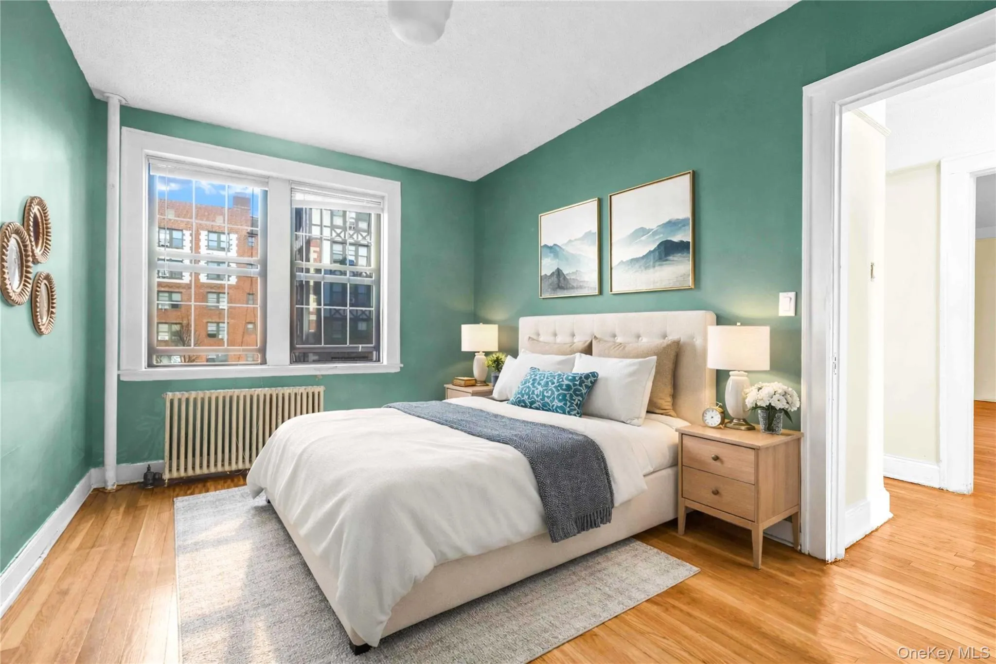 Bedroom featuring radiator and light wood-style flooring Bedroom featuring radiator and light wood-style flooring