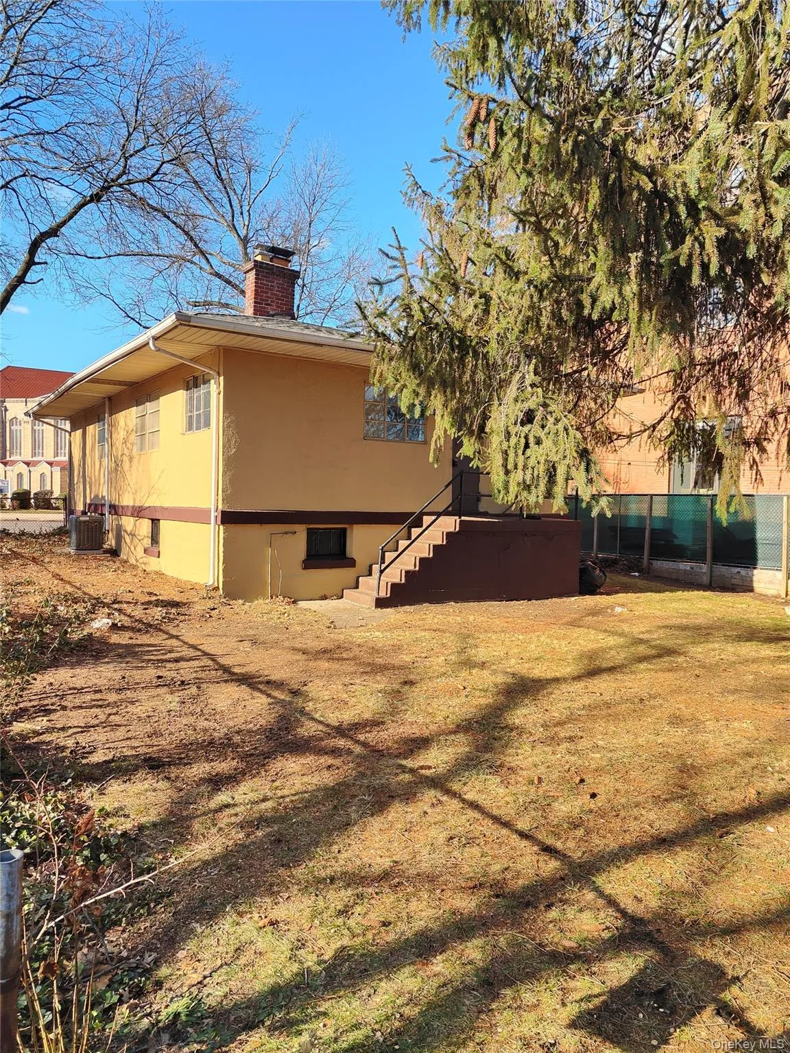 View of side of home featuring a chimney and a central air condition unit View of side of home featuring a chimney and a central air condition unit
