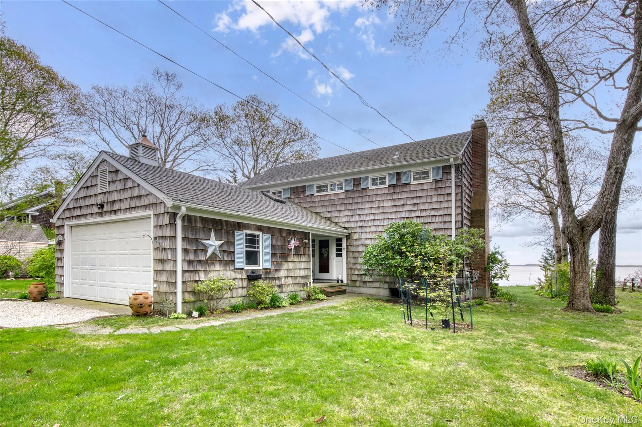 View of front of home featuring a chimney, a front yard, and roof with shingles View of front of home featuring a chimney, a front yard, and roof with shingles