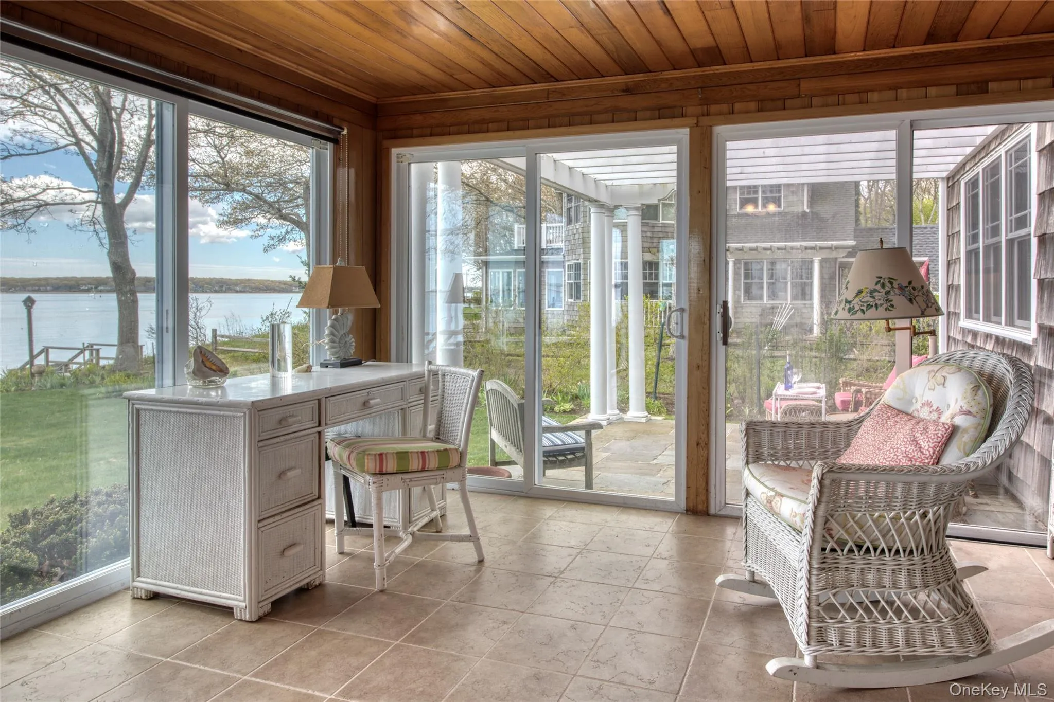 Sunroom featuring a water view, wooden ceiling, and plenty of natural light Sunroom featuring a water view, wooden ceiling, and plenty of natural light