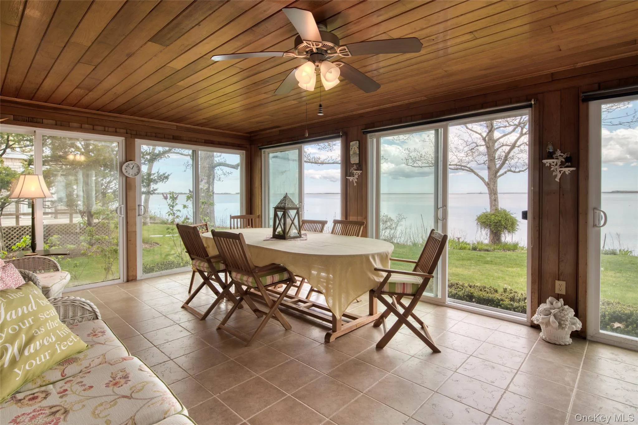 Sunroom with a water view, wooden ceiling, and tile patterned floors Sunroom with a water view, wooden ceiling, and tile patterned floors