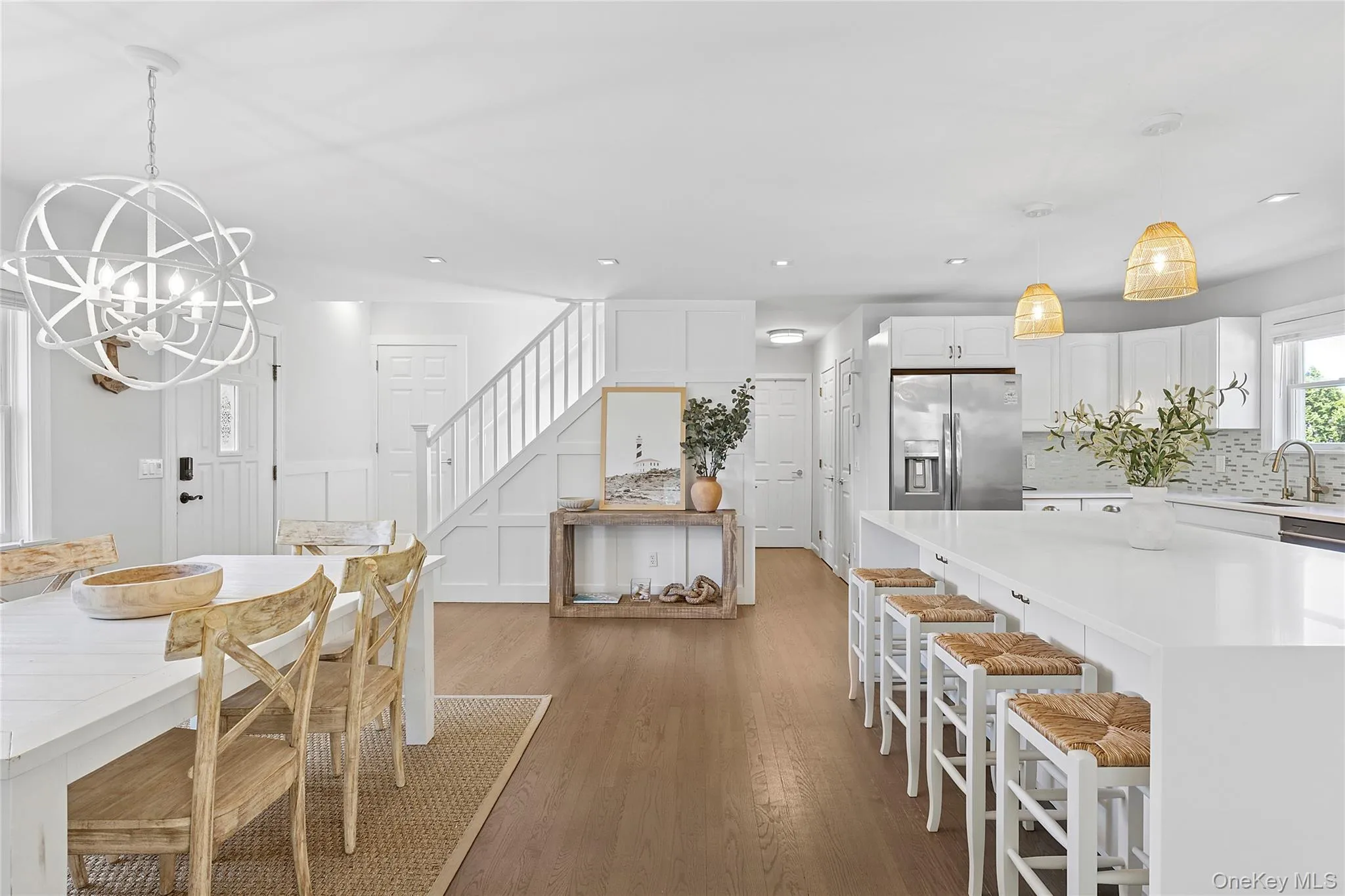 Dining room with a decorative wall, stairs, dark wood finished floors, and a chandelier Dining room with a decorative wall, stairs, dark wood finished floors, and a chandelier