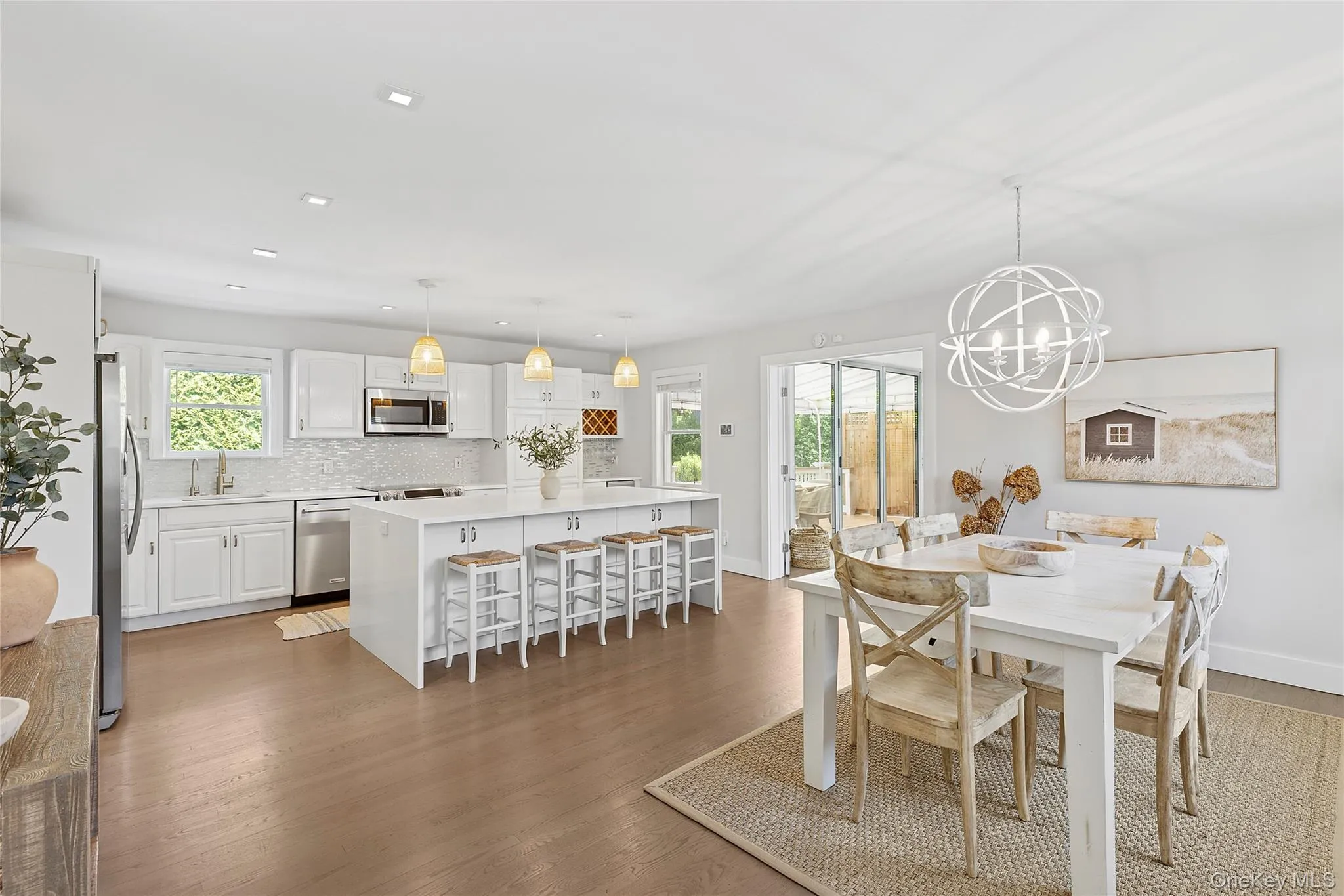 Dining space with wood finished floors, a chandelier, and recessed lighting Dining space with wood finished floors, a chandelier, and recessed lighting