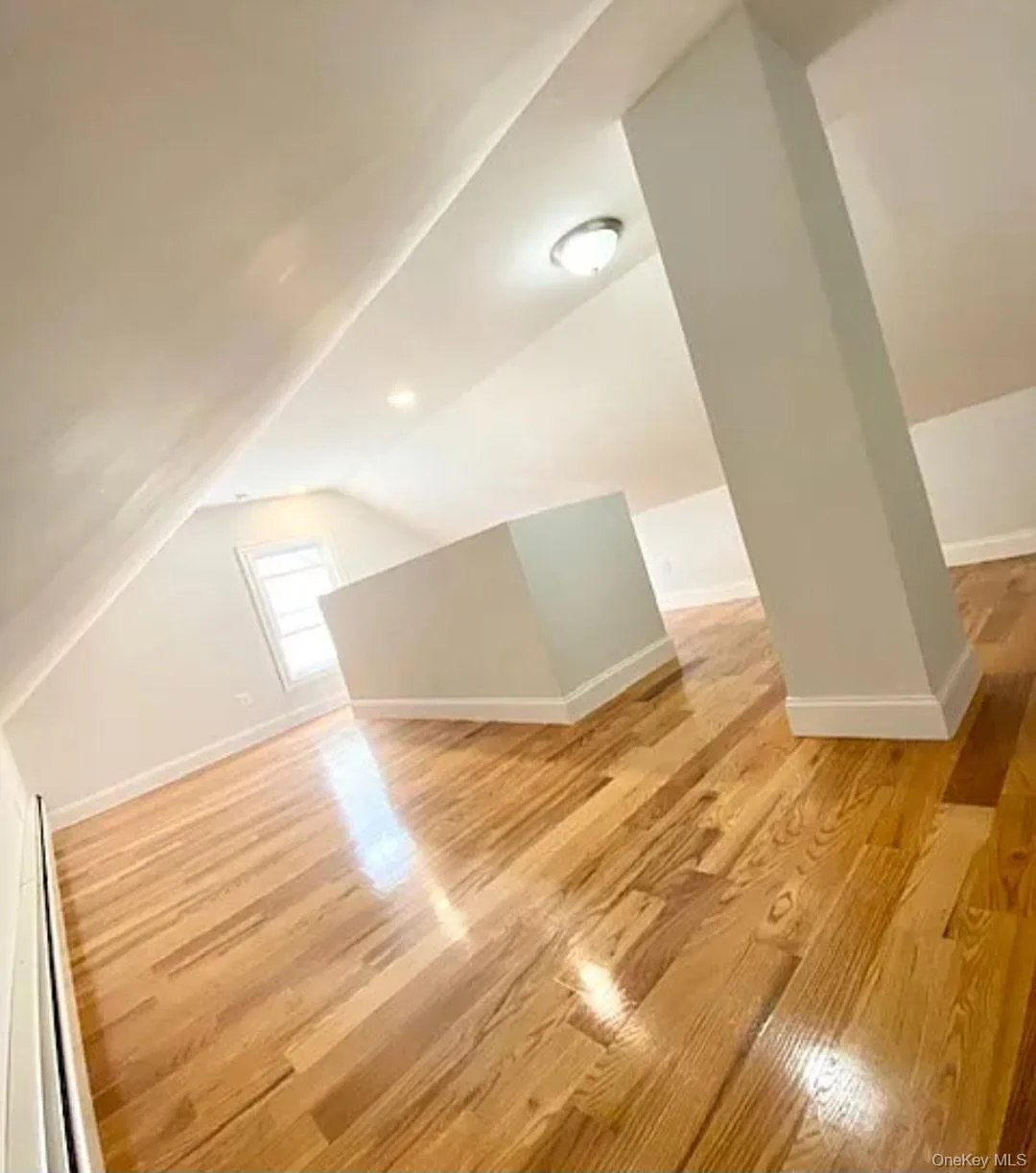 Bonus room featuring lofted ceiling and light wood-style floors Bonus room featuring lofted ceiling and light wood-style floors