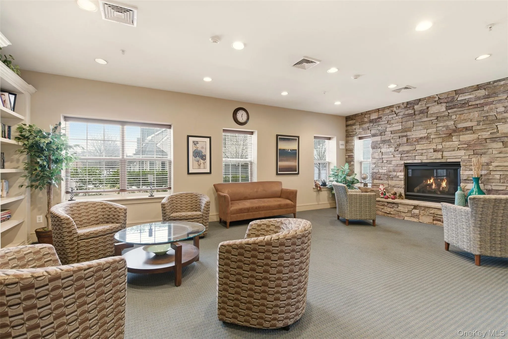 Living area with a fireplace, carpet flooring, and recessed lighting Living area with a fireplace, carpet flooring, and recessed lighting