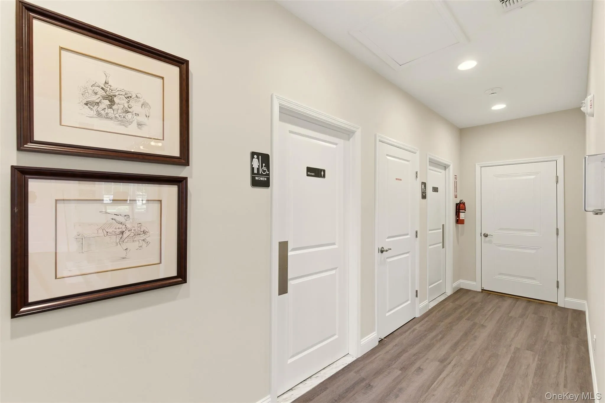 Hallway with recessed lighting and light wood-style flooring Hallway with recessed lighting and light wood-style flooring