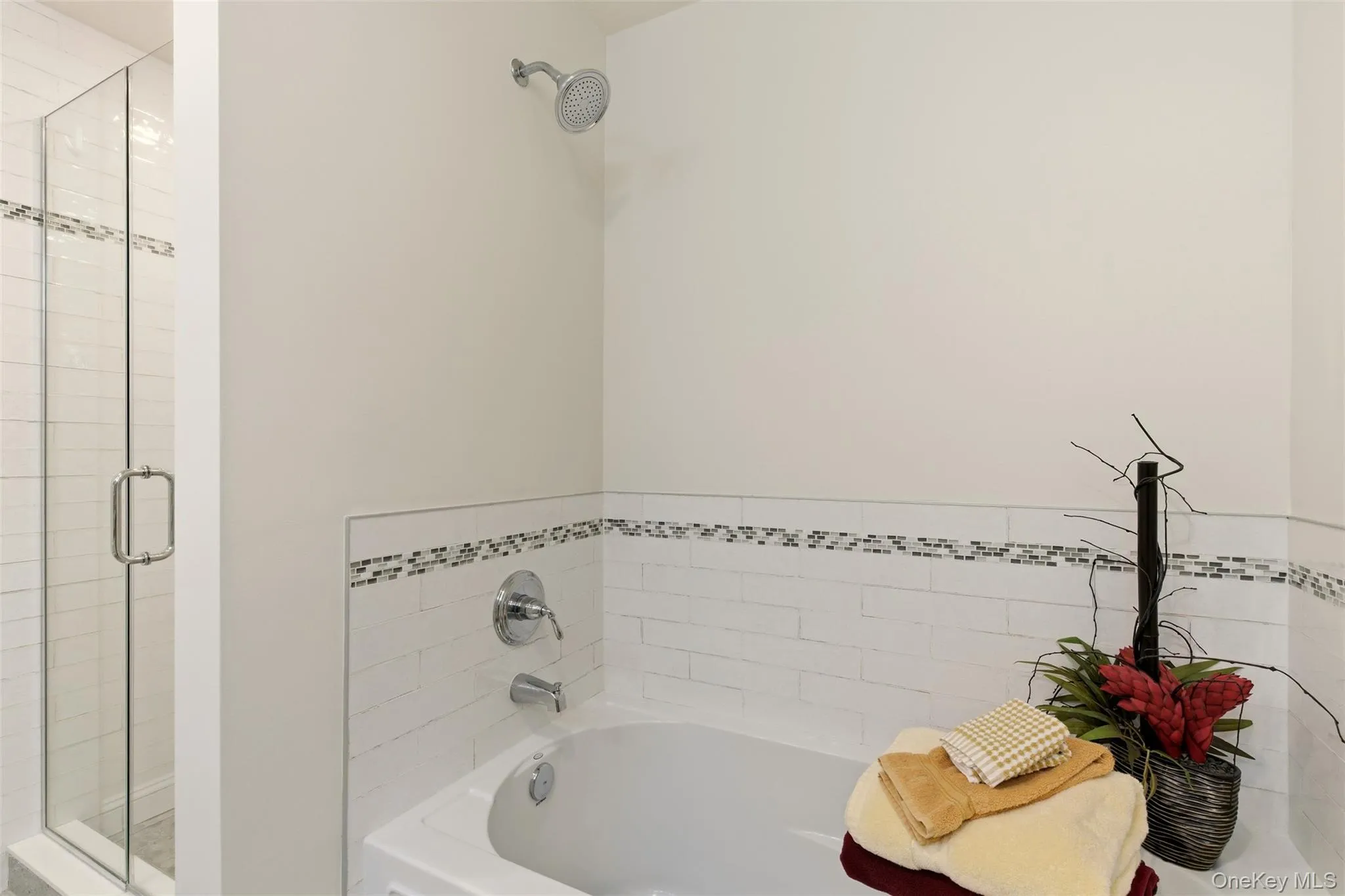 Full bath featuring a bath and a shower stall Full bath featuring a bath and a shower stall
