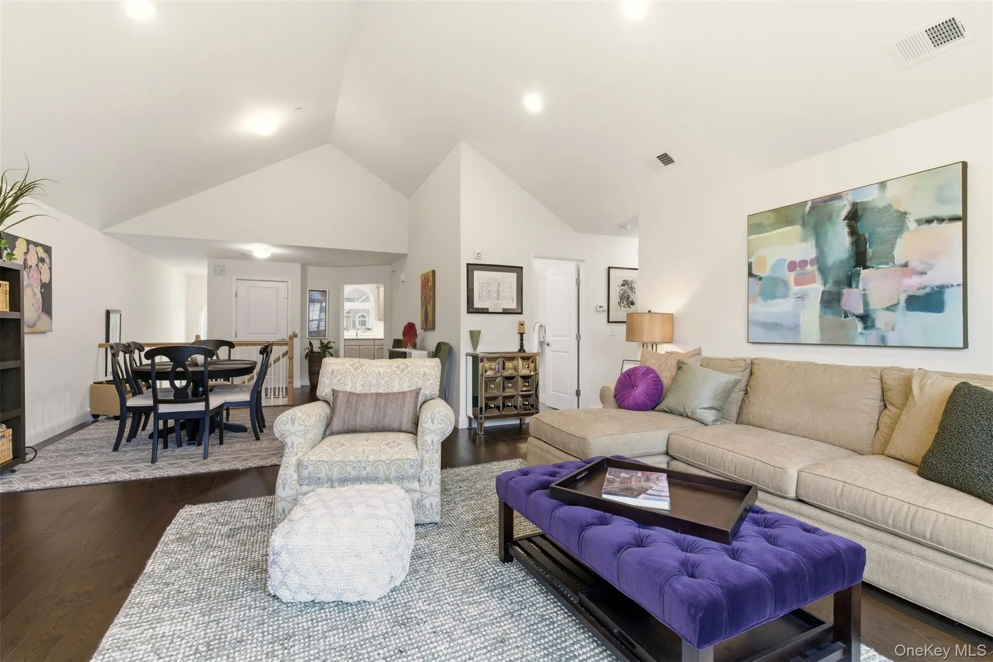 Living area with dark wood-style floors and high vaulted ceiling Living area with dark wood-style floors and high vaulted ceiling