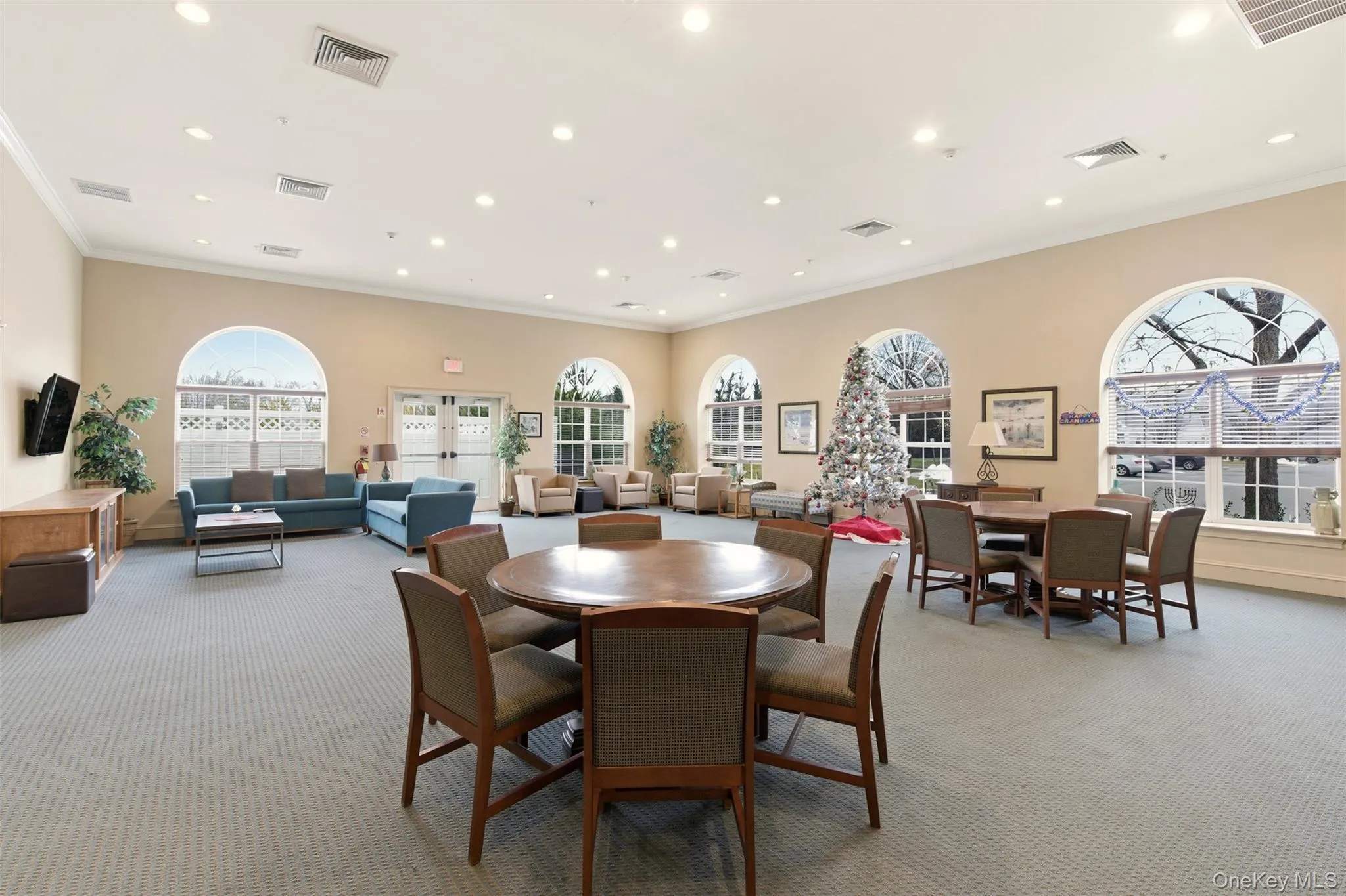 Dining area with crown molding, recessed lighting, light colored carpet, and plenty of natural light Dining area with crown molding, recessed lighting, light colored carpet, and plenty of natural light