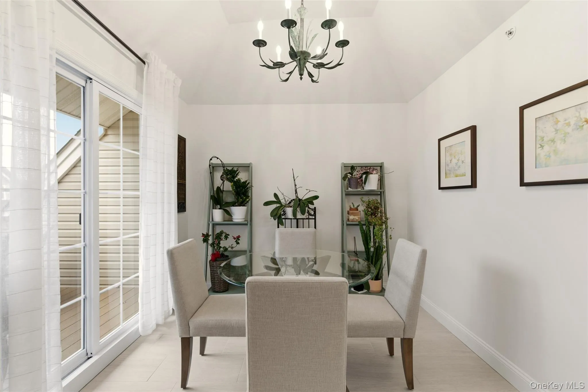 Dining area with a chandelier and lofted ceiling Dining area with a chandelier and lofted ceiling
