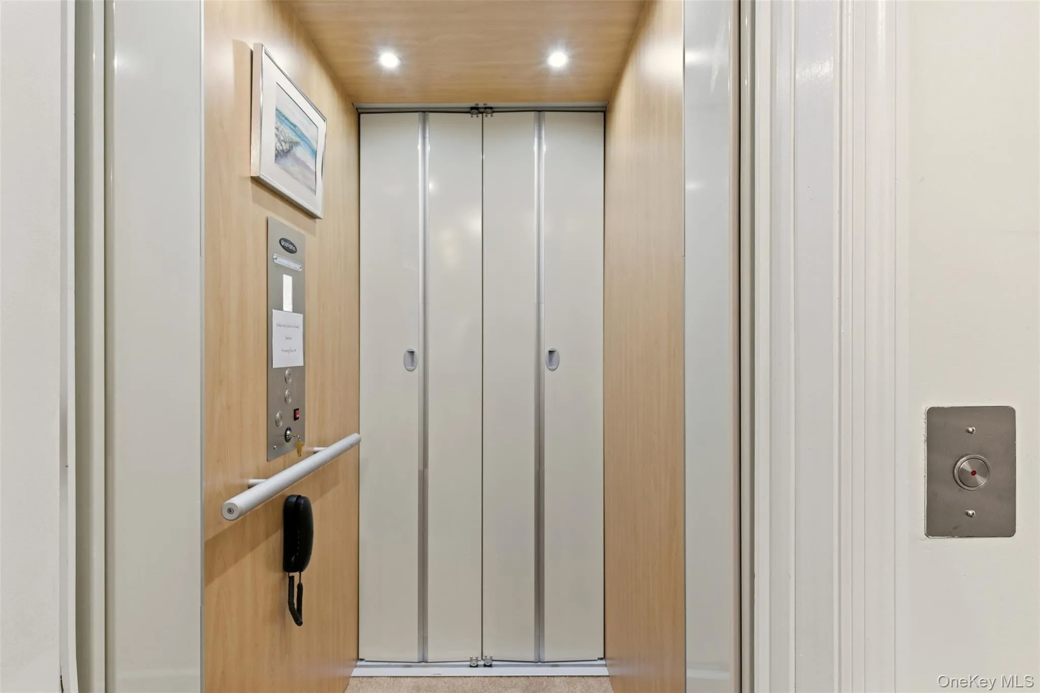 Elevator with recessed lighting and wooden ceiling Elevator with recessed lighting and wooden ceiling