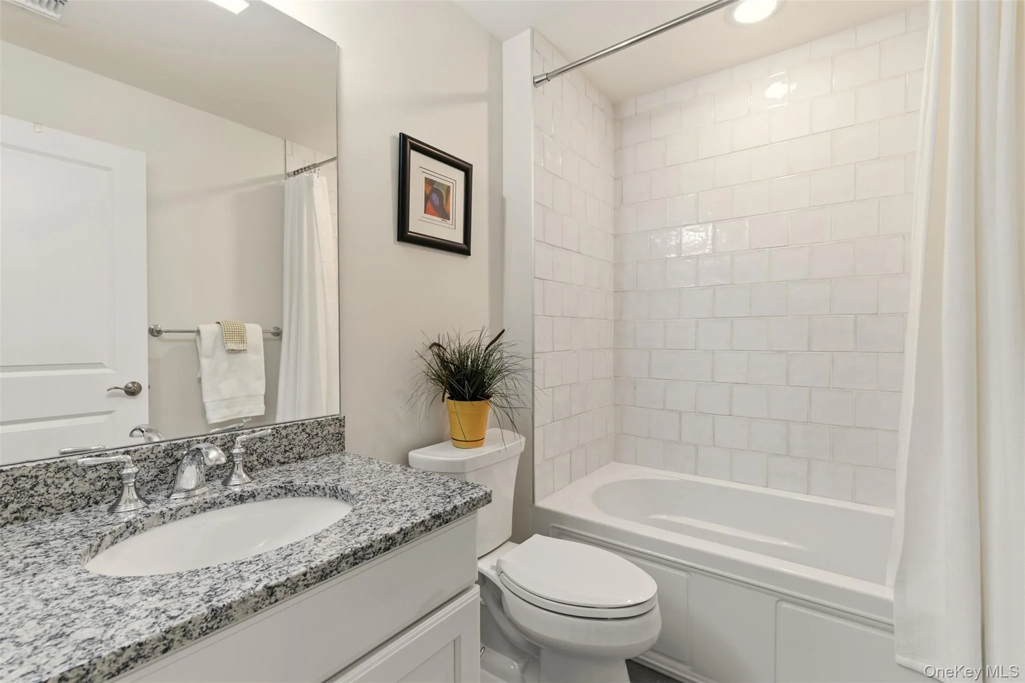 Full bathroom with vanity and shower / bath combination with curtain Full bathroom with vanity and shower / bath combination with curtain