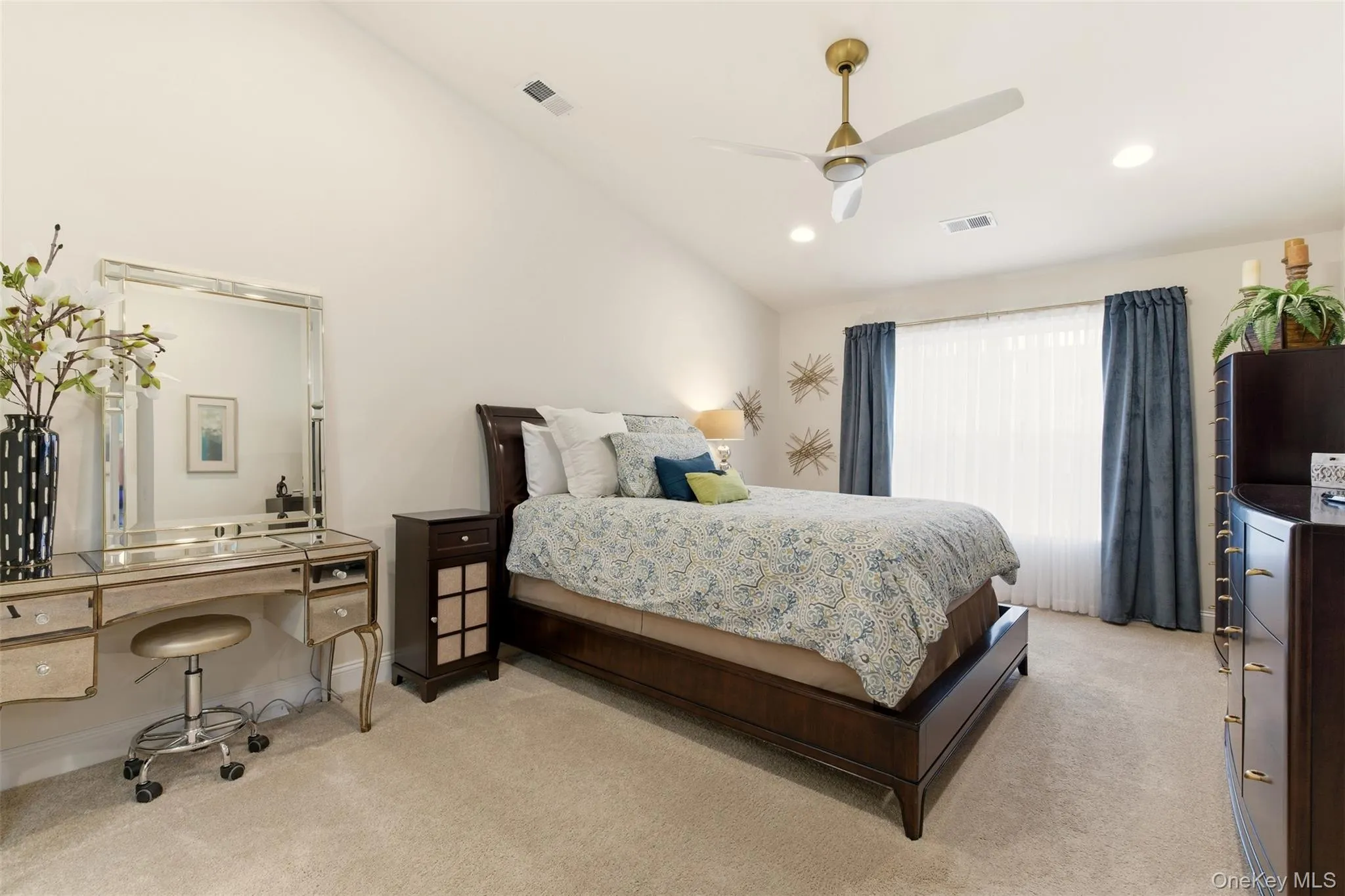 Bedroom with lofted ceiling, ceiling fan, light colored carpet, and recessed lighting Bedroom with lofted ceiling, ceiling fan, light colored carpet, and recessed lighting
