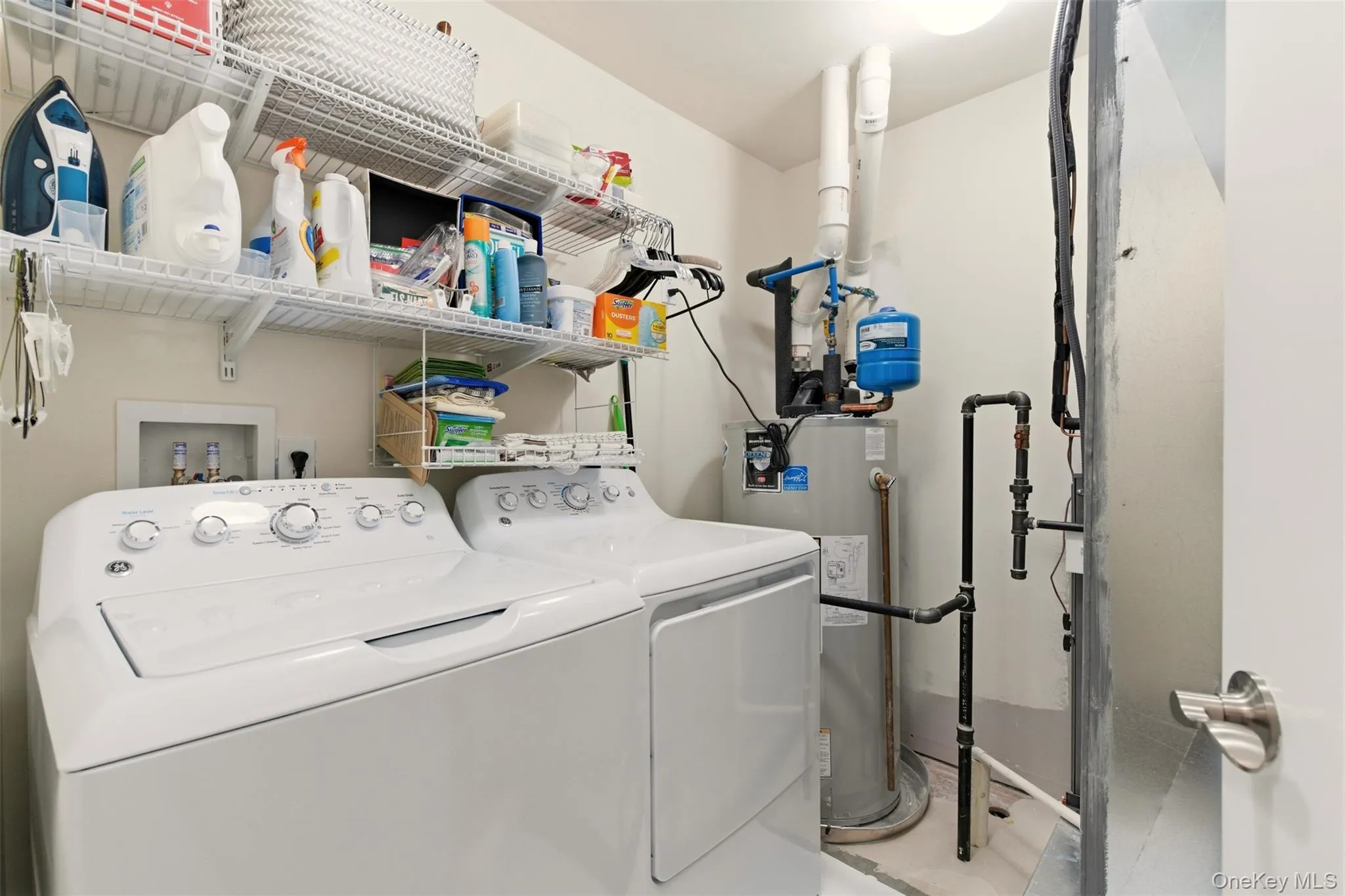 Laundry room featuring water heater and separate washer and dryer Laundry room featuring water heater and separate washer and dryer