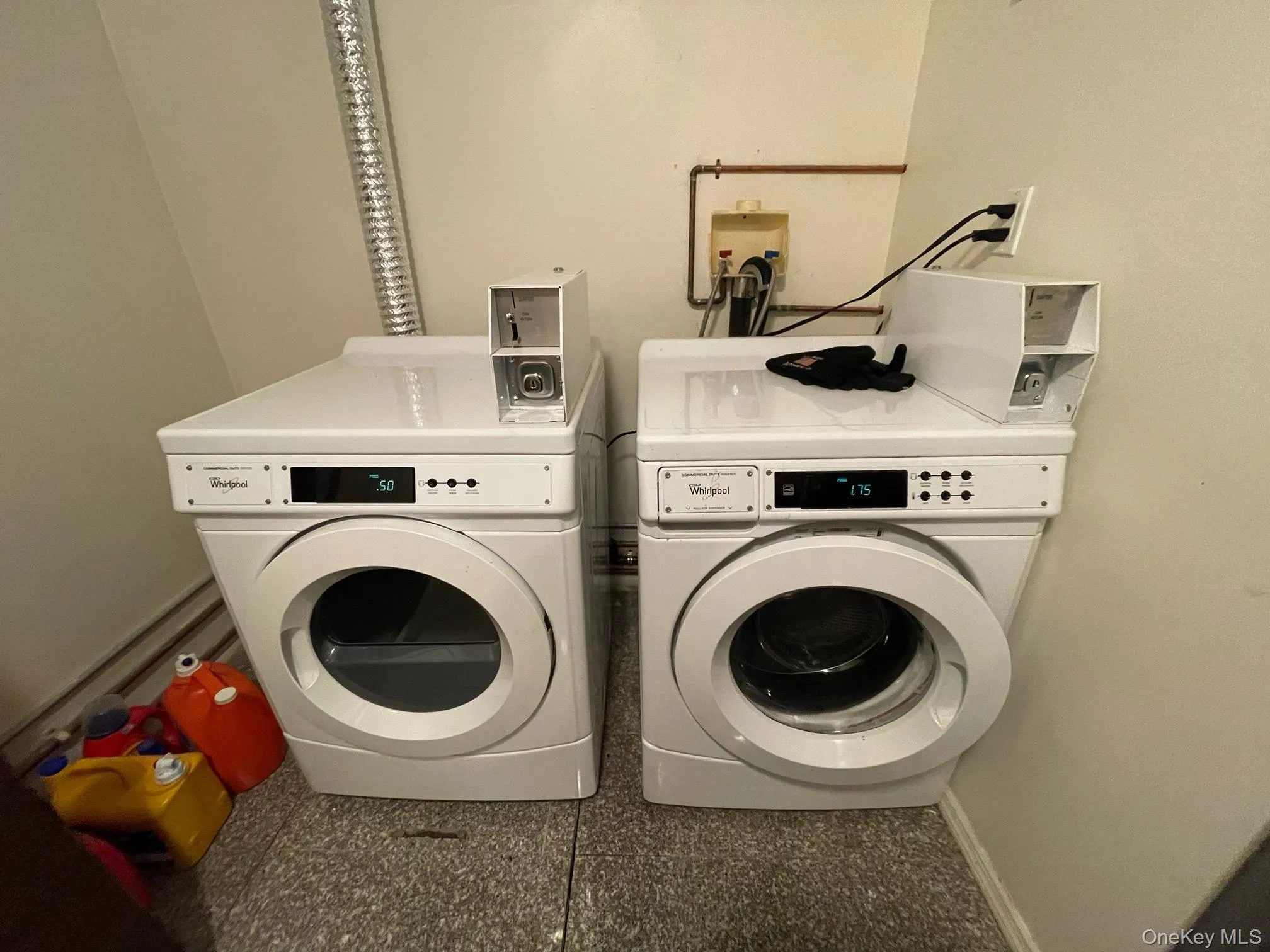 Washroom with washer and dryer and baseboards Washroom with washer and dryer and baseboards