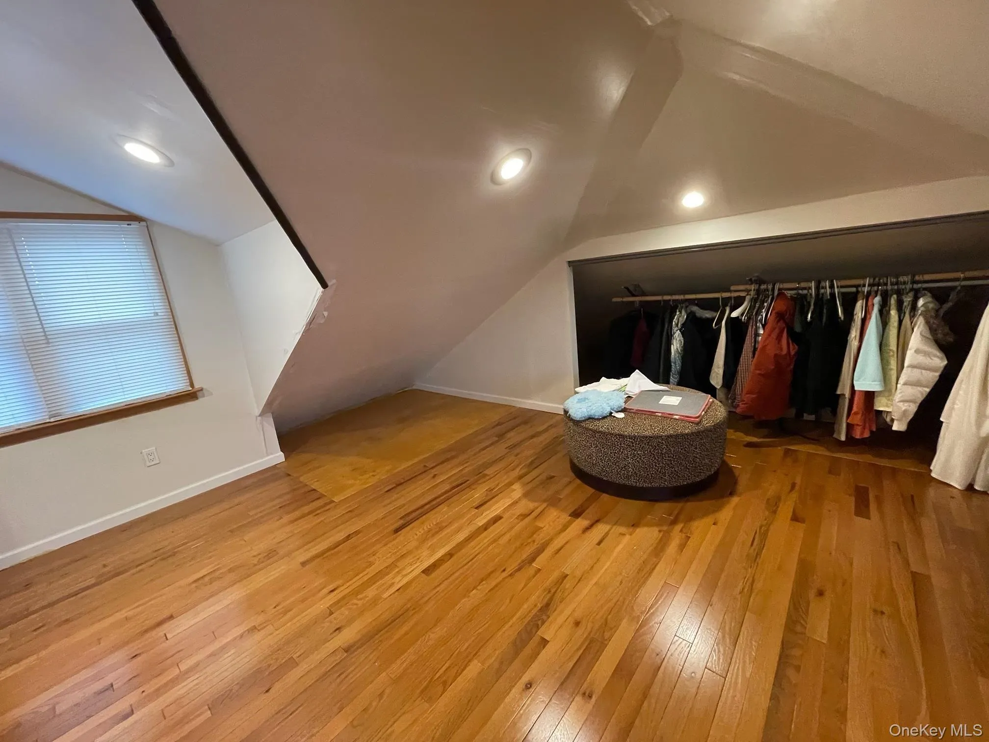 Bonus room with vaulted ceiling and light wood-style floors Bonus room with vaulted ceiling and light wood-style floors