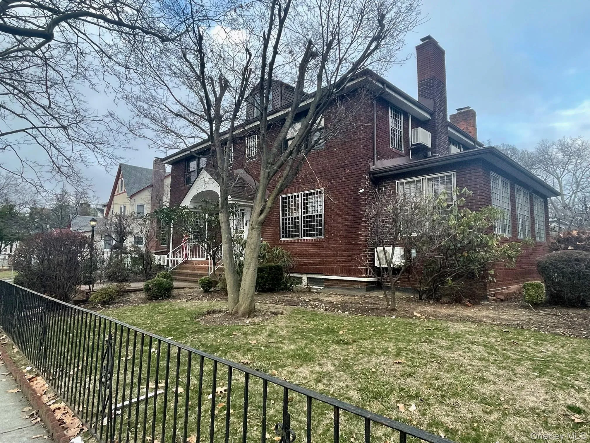 View of home's exterior with a chimney and brick siding View of home's exterior with a chimney and brick siding