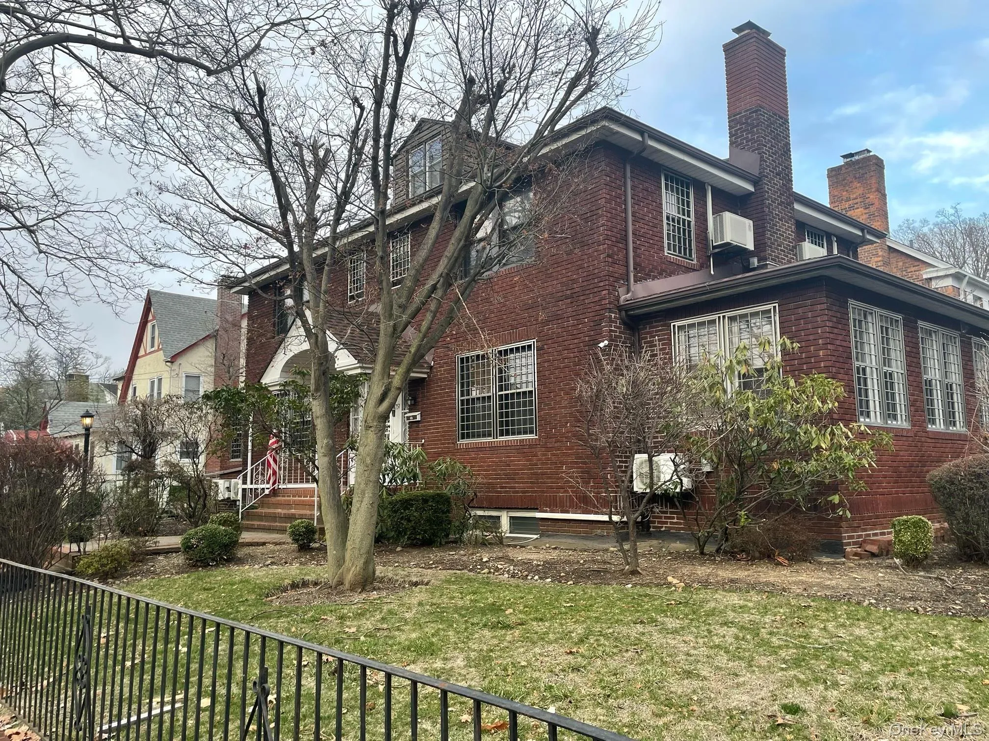 View of side of property featuring brick siding and a chimney View of side of property featuring brick siding and a chimney
