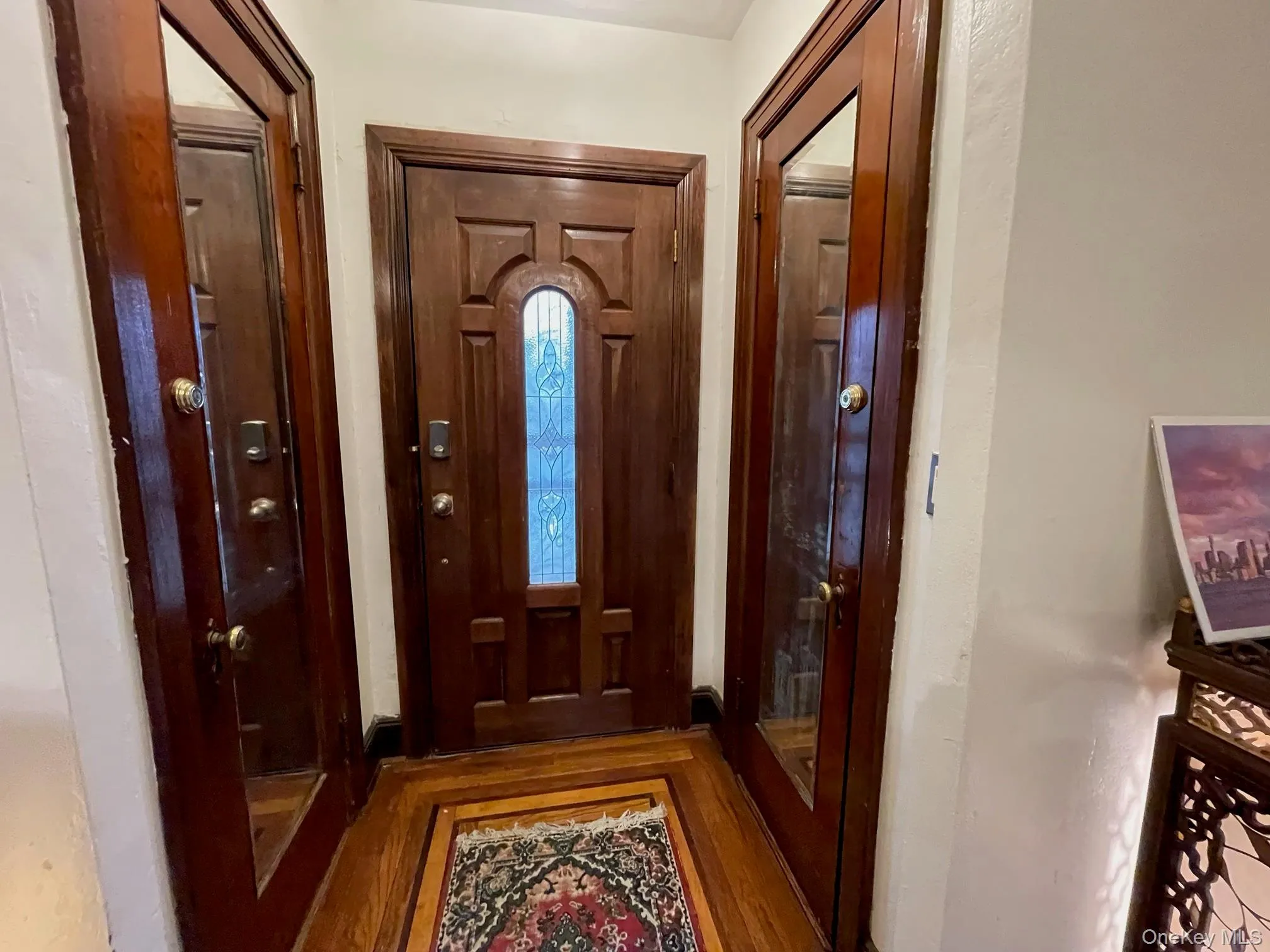 Foyer entrance featuring wood finished floors Foyer entrance featuring wood finished floors