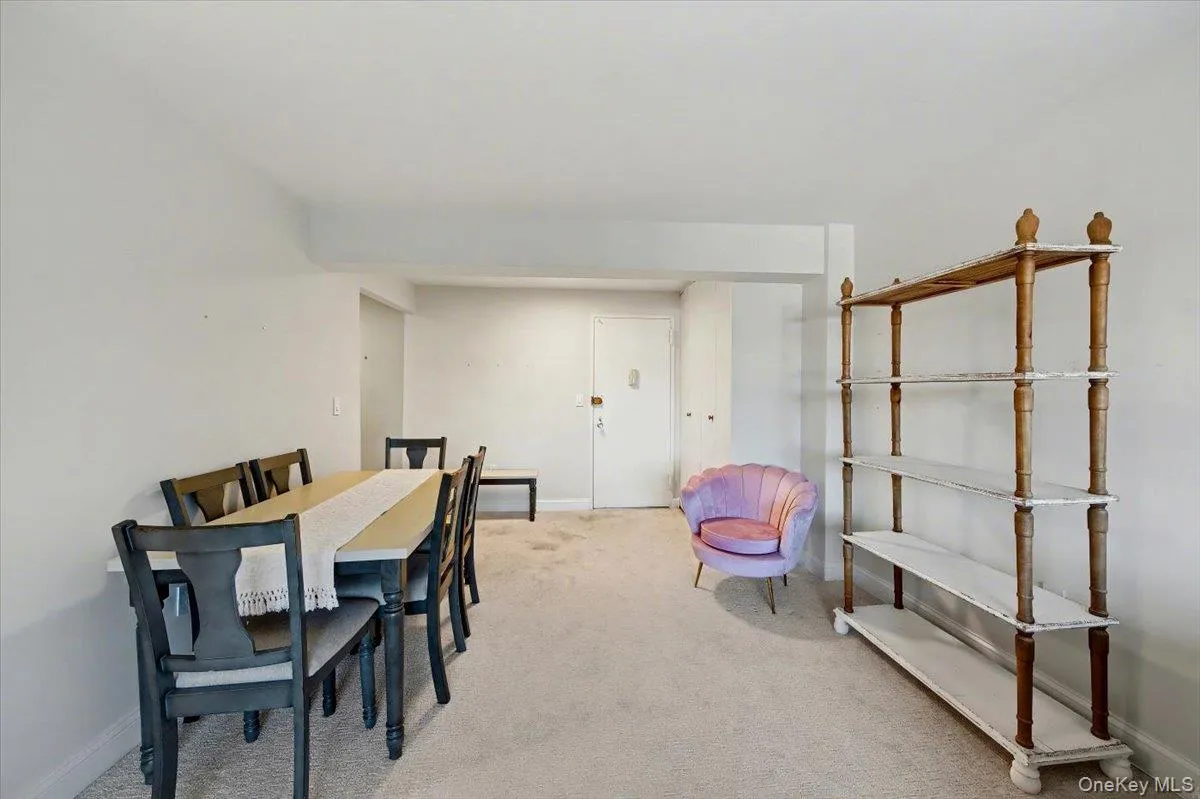 Dining room featuring light colored carpet and baseboards Dining room featuring light colored carpet and baseboards
