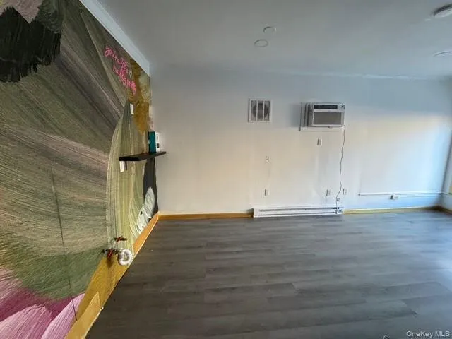 View of the interior of the store with exhaust fan on the wall and wall A/C unit. View of the interior of the store with exhaust fan on the wall and wall A/C unit.